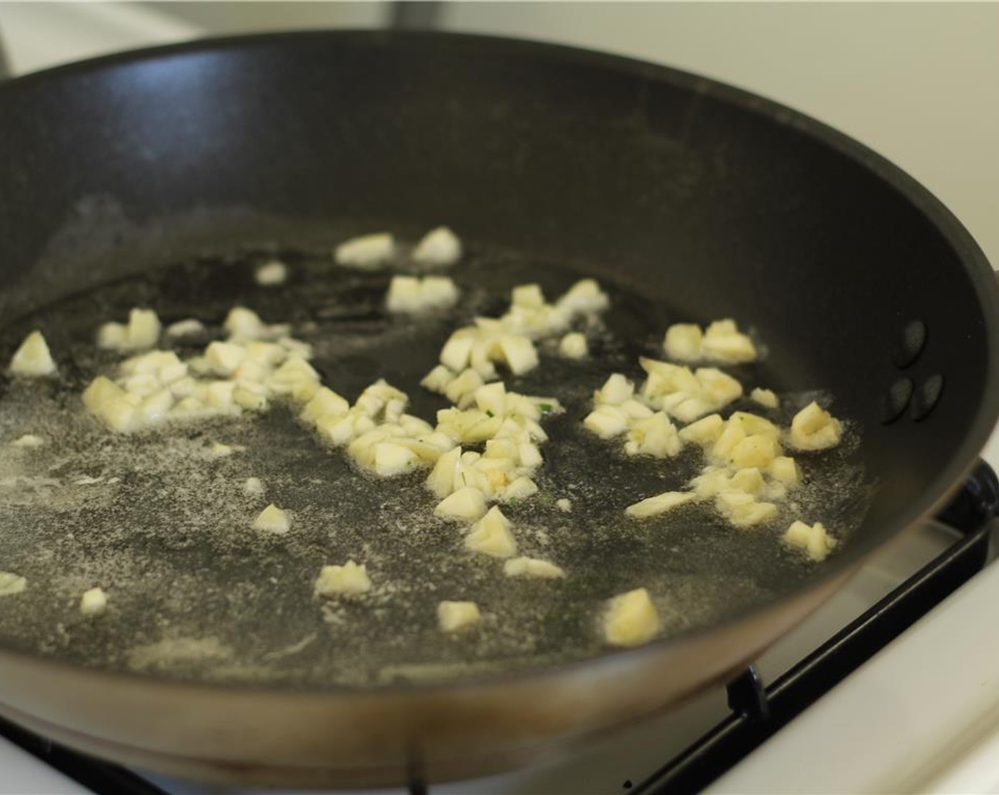 step 5 Dice the Garlic (4 cloves). Melt the Butter (2 Tbsp) in a pan, and add the garlic to the pan.