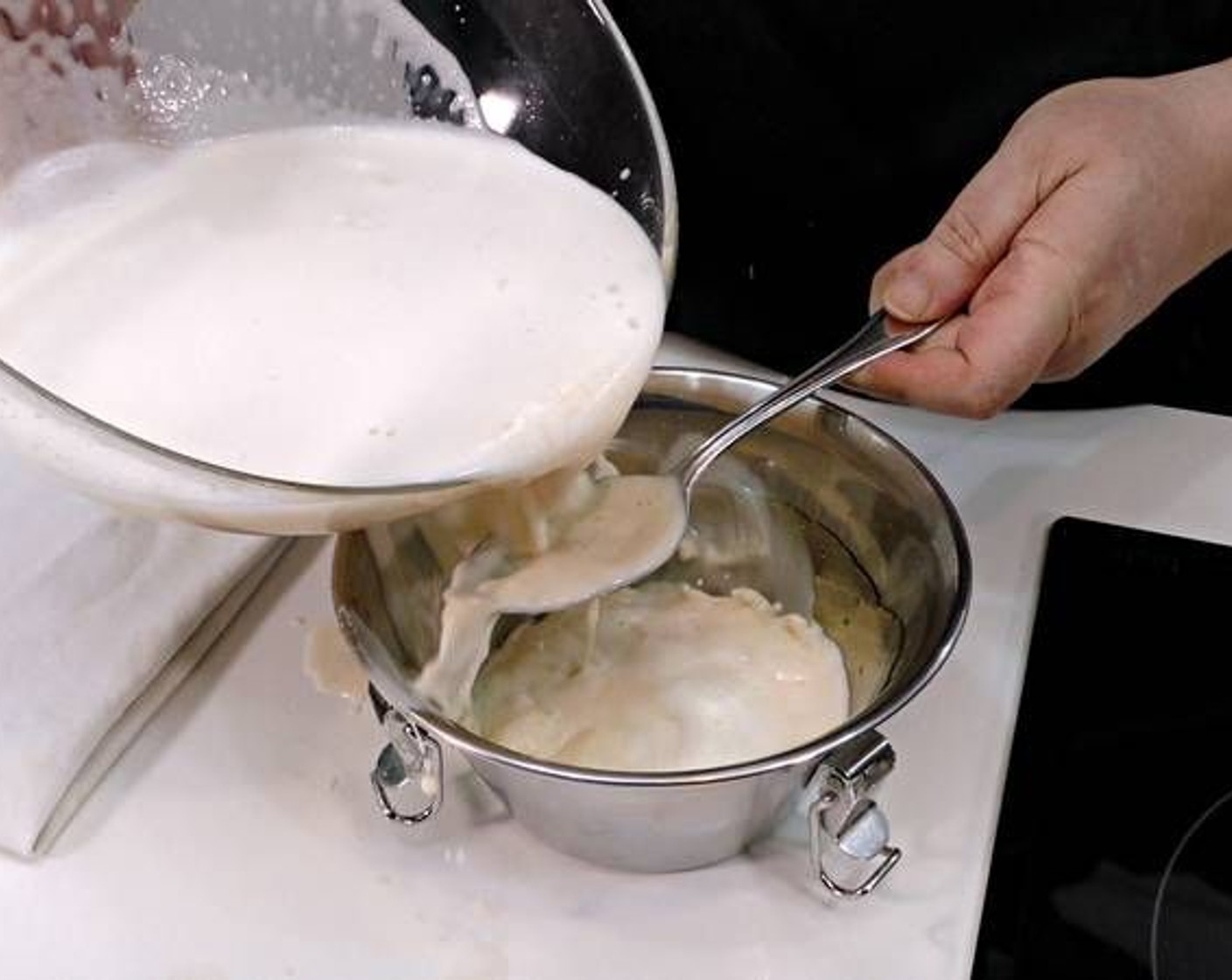 step 4 Pour the mixture into the metal pot with a spoon underneath as you pour to avoid it splashing out the pot.