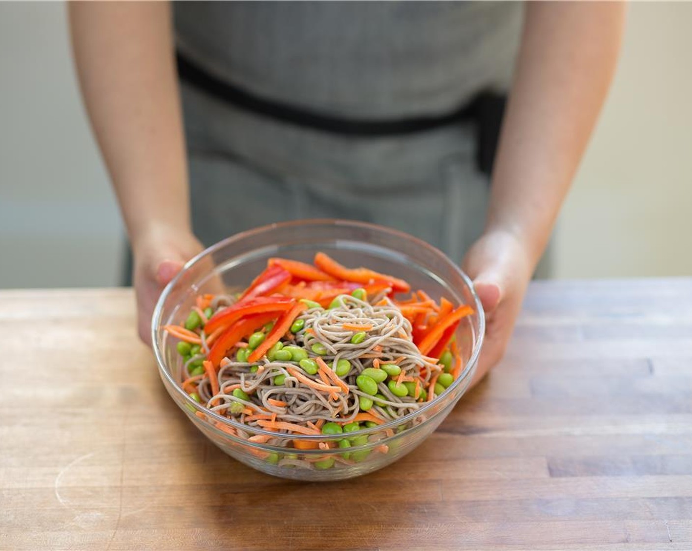step 7 Place the noodles in a large bowl and add the bell peppers, carrots and Edamame (1/2 cup). Mix to combine.