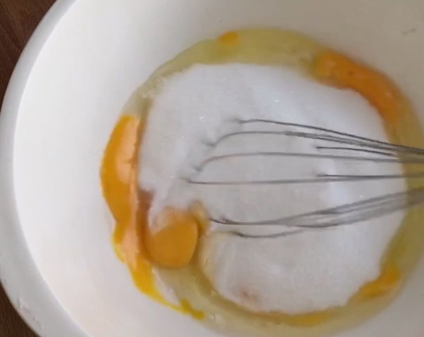 step 6 Using a large mixing bowl, prepare the wet ingredients. Add in Eggs (4) and Granulated Sugar (2 1/2 cups). Whisk together till sugar dissolves.