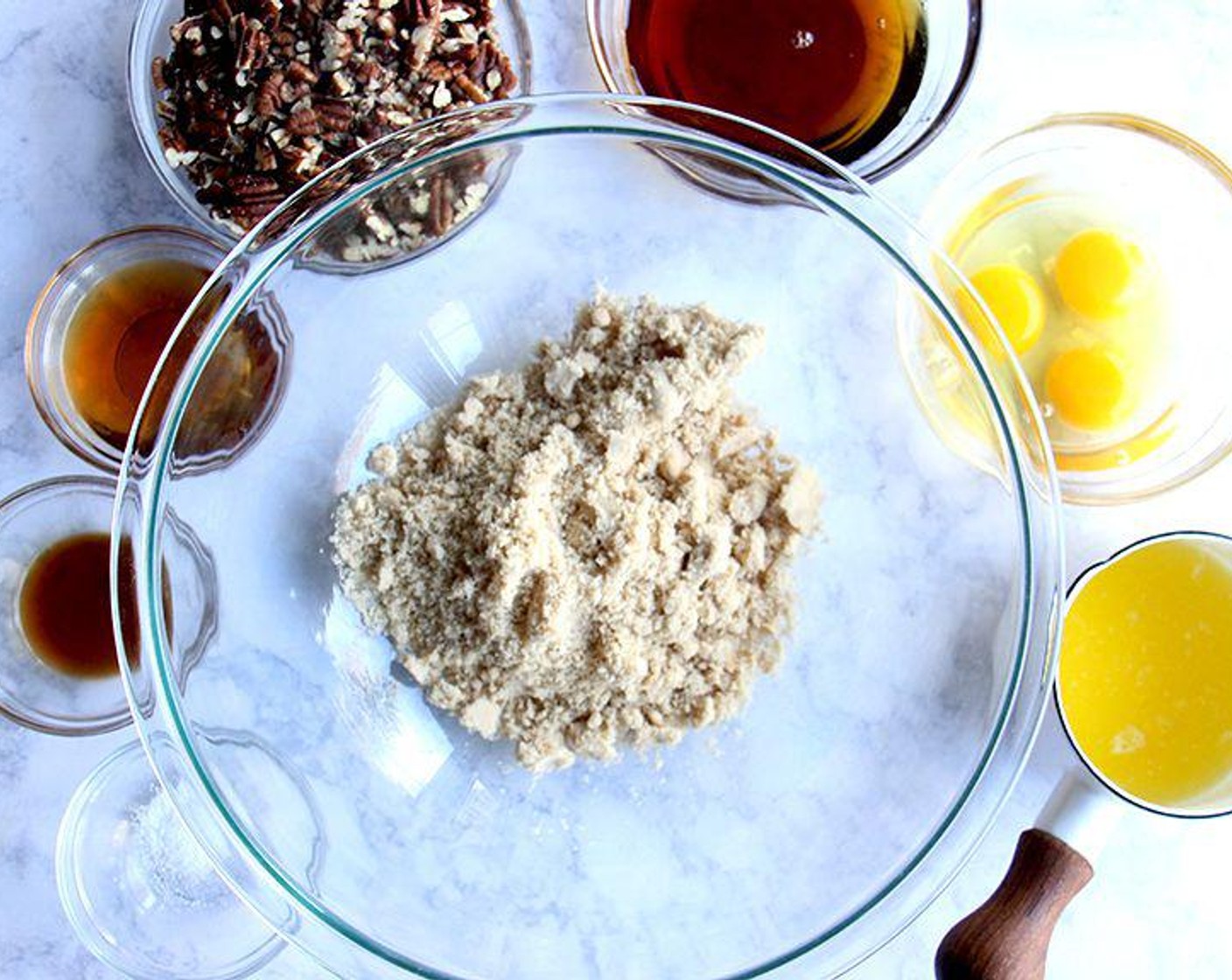 step 6 To make the filling, in a large bowl, whisk together the Dark Brown Sugar (1 cup), Maple Syrup (1/2 cup), Farmhouse Eggs® Large Brown Eggs (3), Butter (1/4 cup), Bourbon (3 Tbsp), Vanilla Extract (1 tsp), and Salt (1/4 tsp). Stir in the Roasted Pecans (2 cups).