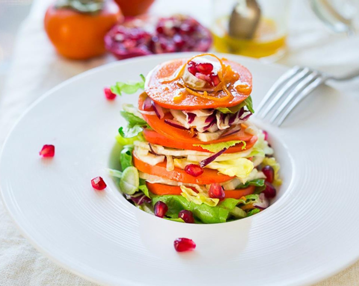 step 5 This salad is also very pretty served plated. To plate the salad -layer slices of persimmon with dressed lettuce fennel mixture, and top with pomegranate.