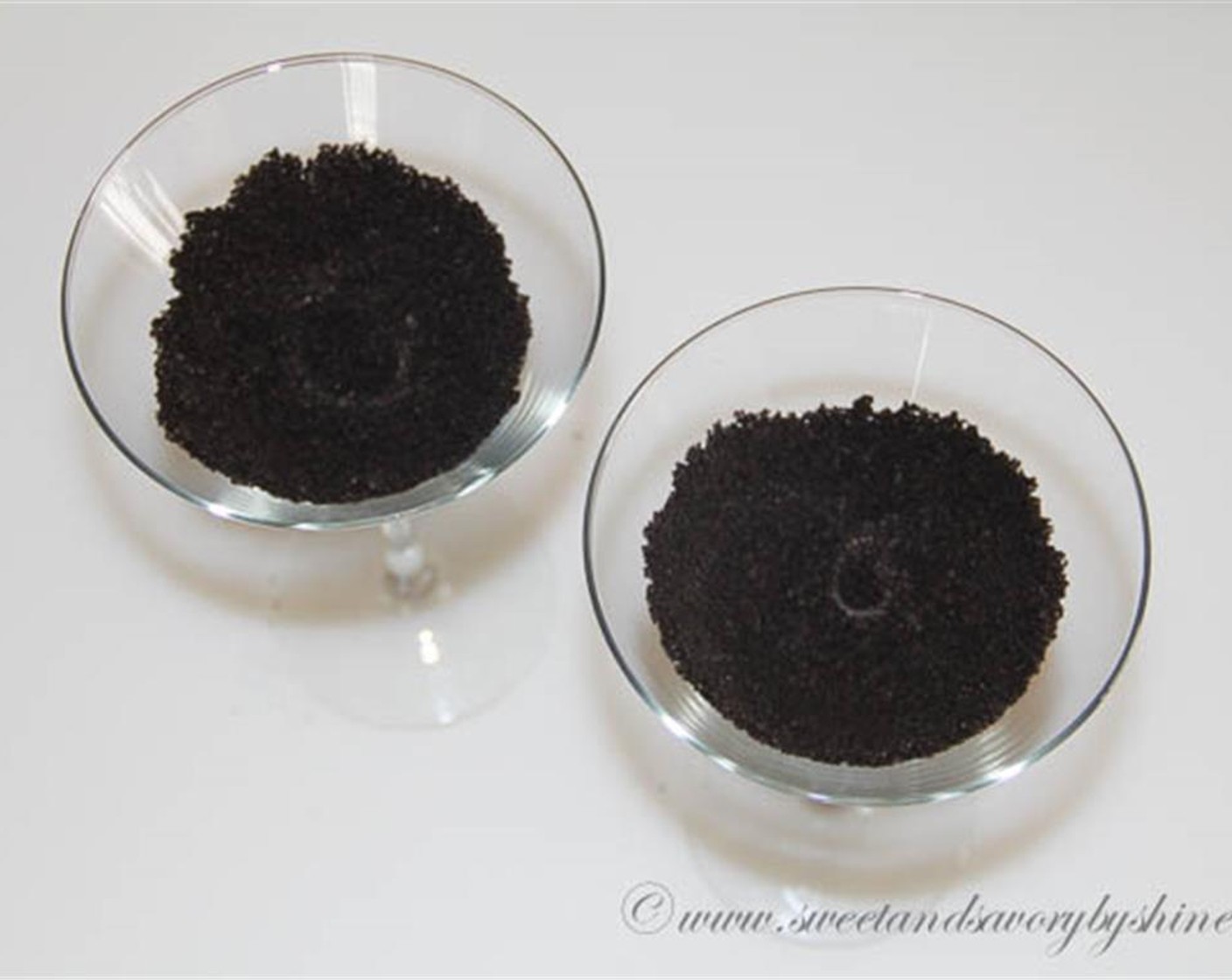 step 1 Crumble the Oreo® Chocolate Sandwich Cookies (4) in a food processor. Divide the Oreo crumbs into 2 glasses. Press the cookie crumbs evenly along the sides and set aside.