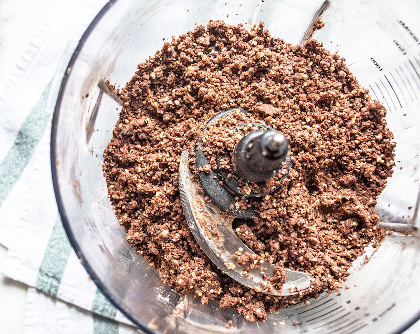 step 6 Scrape down sides and add Pea Protein Powder (1/4 cup), Cacao Powder (1/3 cup), toasted quinoa, and Vanilla Extract (1 tsp) continue to blend another 15-20 seconds, stopping to scrape down sides as needed. The mixture should be a fine crumbly consistency.