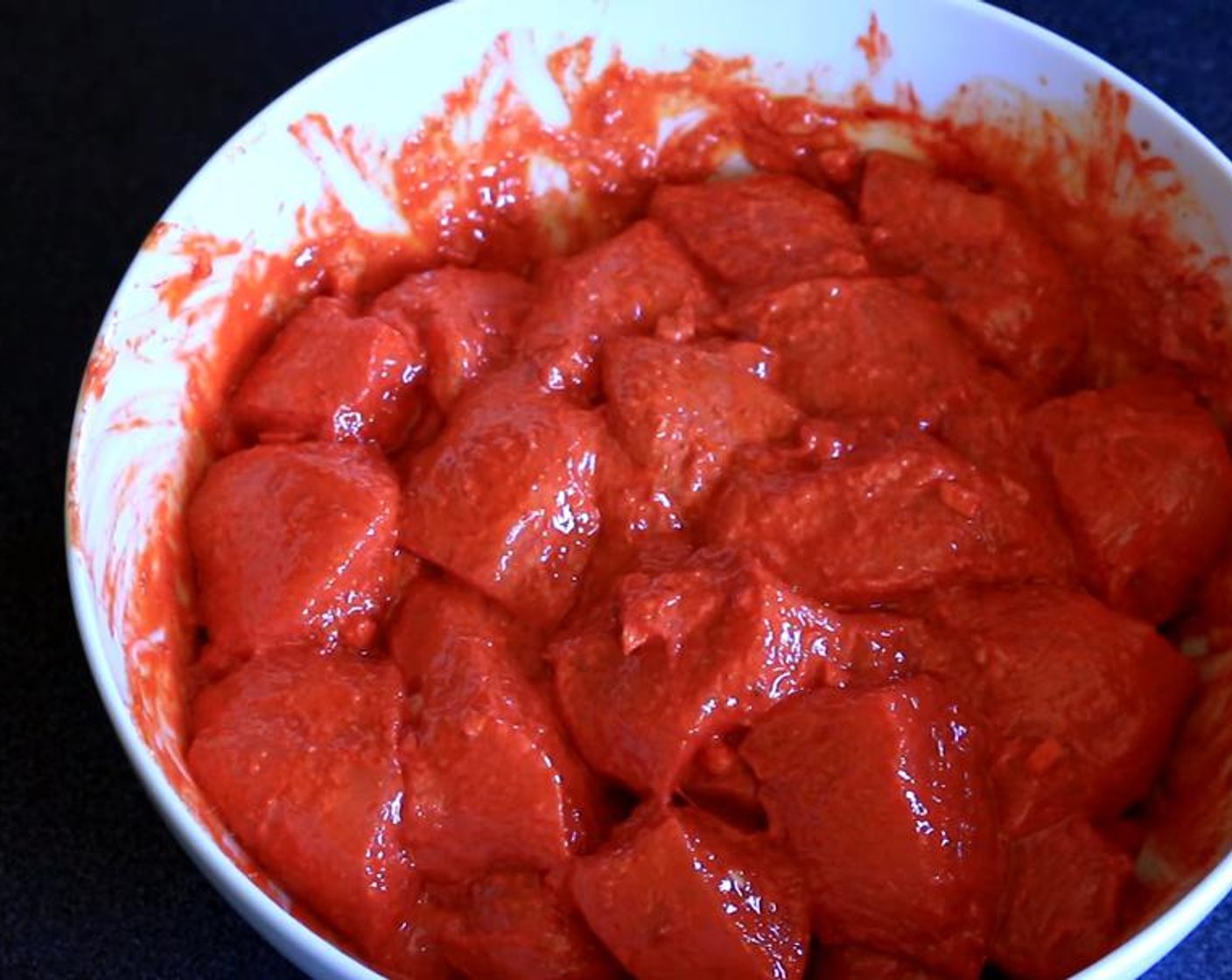 step 2 Add Tandoori Masala Mix (1 Tbsp), Salt (1/2 Tbsp), Fresh Ginger (1 Tbsp), Garlic (1 clove), juice from Lemon (1), Red Food Coloring (1/2 tsp), Vegetable Oil (2 Tbsp), Greek Yogurt (1/3 cup), and Chili Powder (1/2 tsp). Mix well.