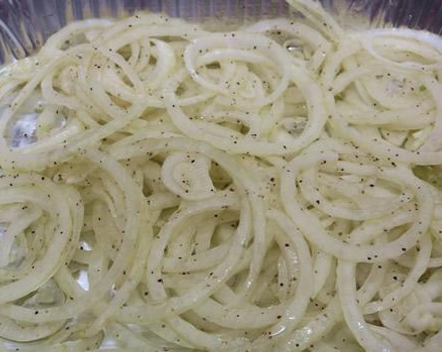 step 3 Place the roast on one side of the cooking grate. Toss the Sweet Onion (1) in a half-size aluminum pan with Olive Oil (1/2 Tbsp), Salt (to taste), and Ground Black Pepper (to taste). Place the pan on the cooking grate with the roast.