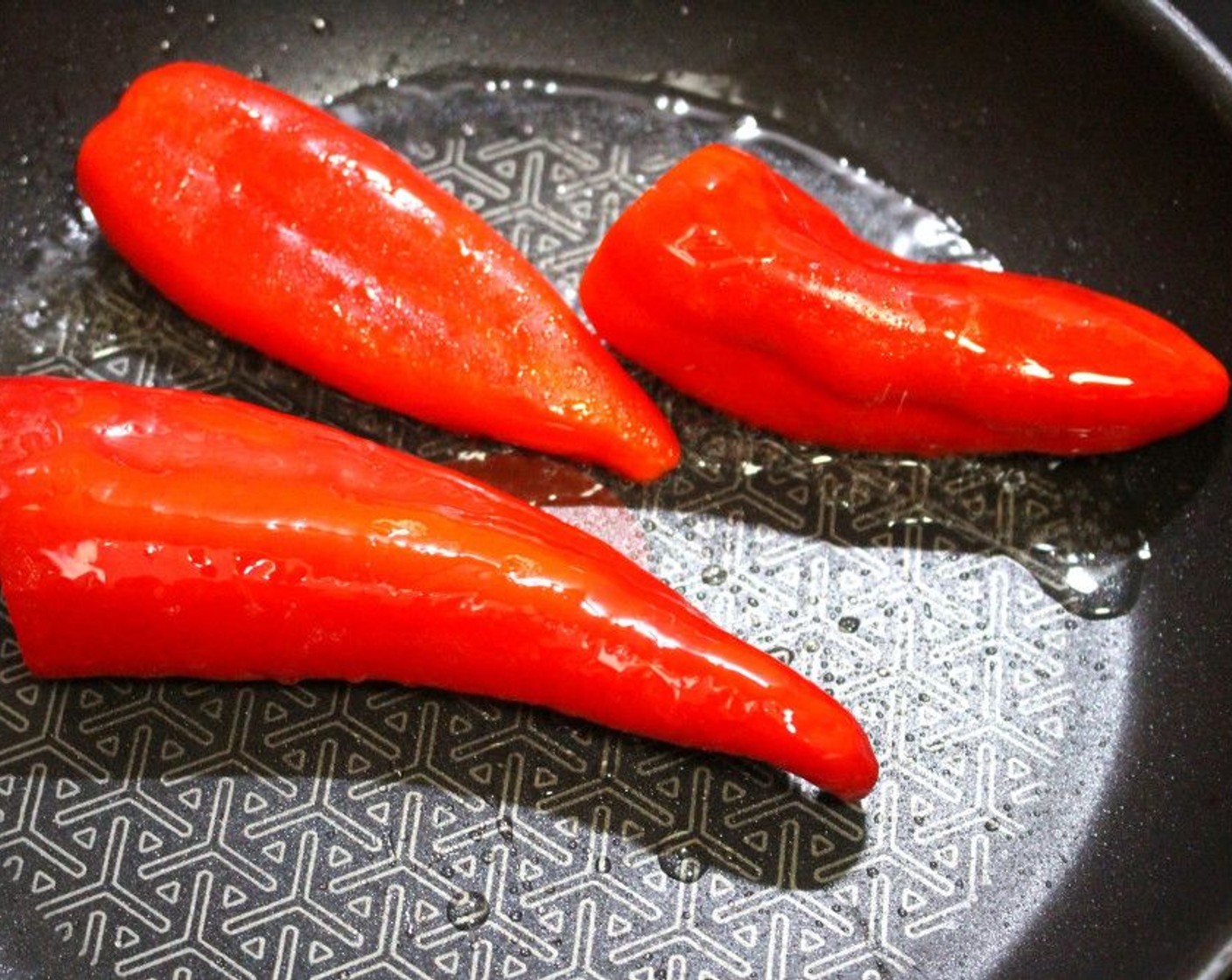 step 2 In a pan add some Olive Oil (1 tsp). Season your Red Bell Peppers (3) with Salt (to taste) and Granulated Garlic (to taste) and sauté in oil until slightly browned.