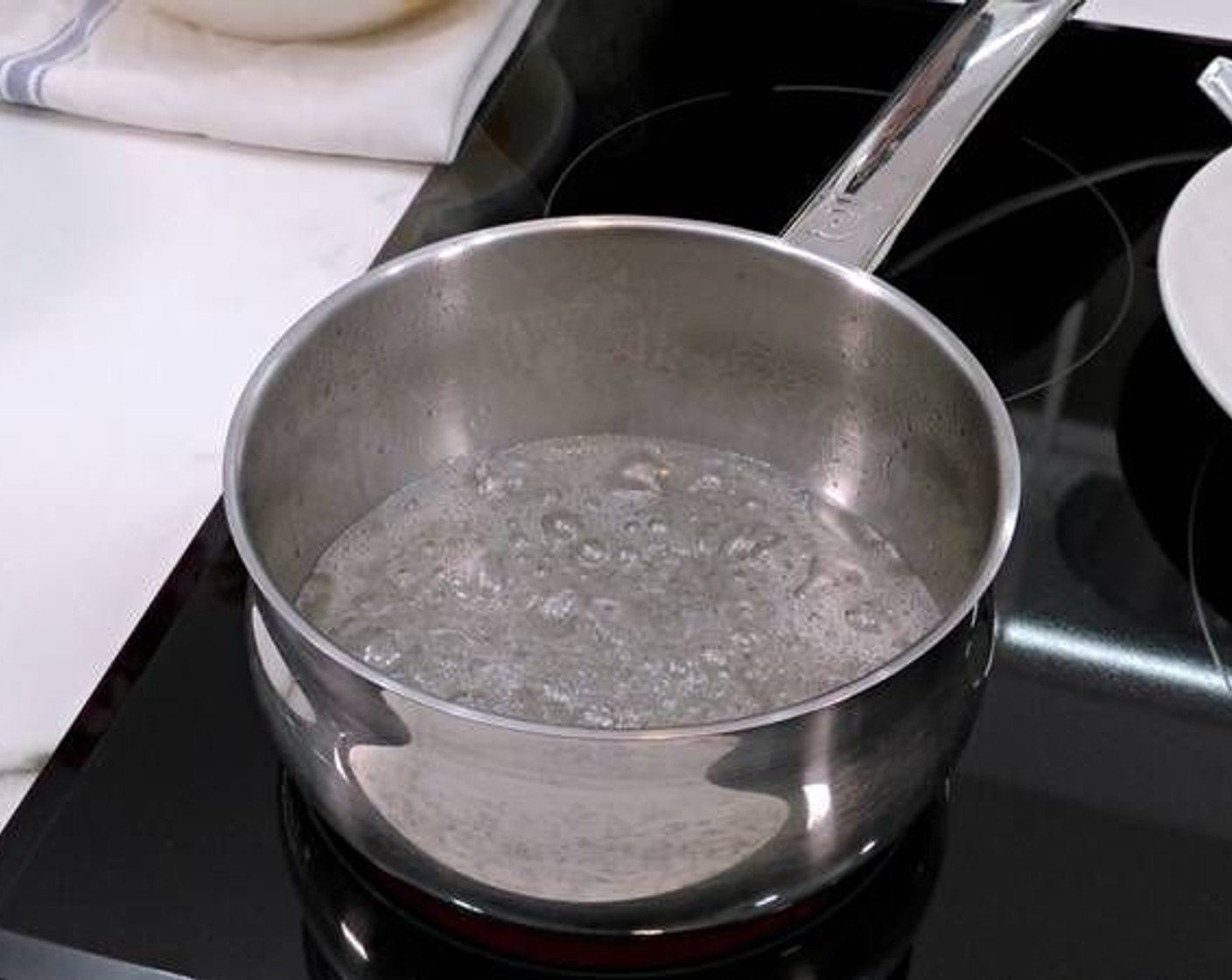 step 1 Start by making the caramel. In a sauce pot add the Granulated Sugar (1/4 cup) and  
Water (1/4 cup) over high heat. Continue to stir and eventually it will start to acquire a golden color. Remove once you have reached a level of bitterness you desire as the longer you leave it on the stove the more bitter the sauce.