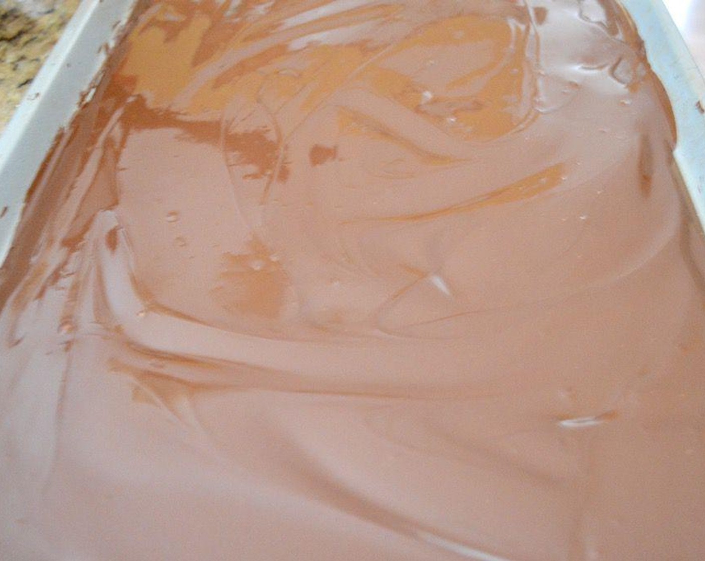 step 4 Stir that all together until the chocolate is completely smooth and shiny. Pour it out onto the lined sheet tray and smooth it out to be even. Set it aside to set for half an hour.