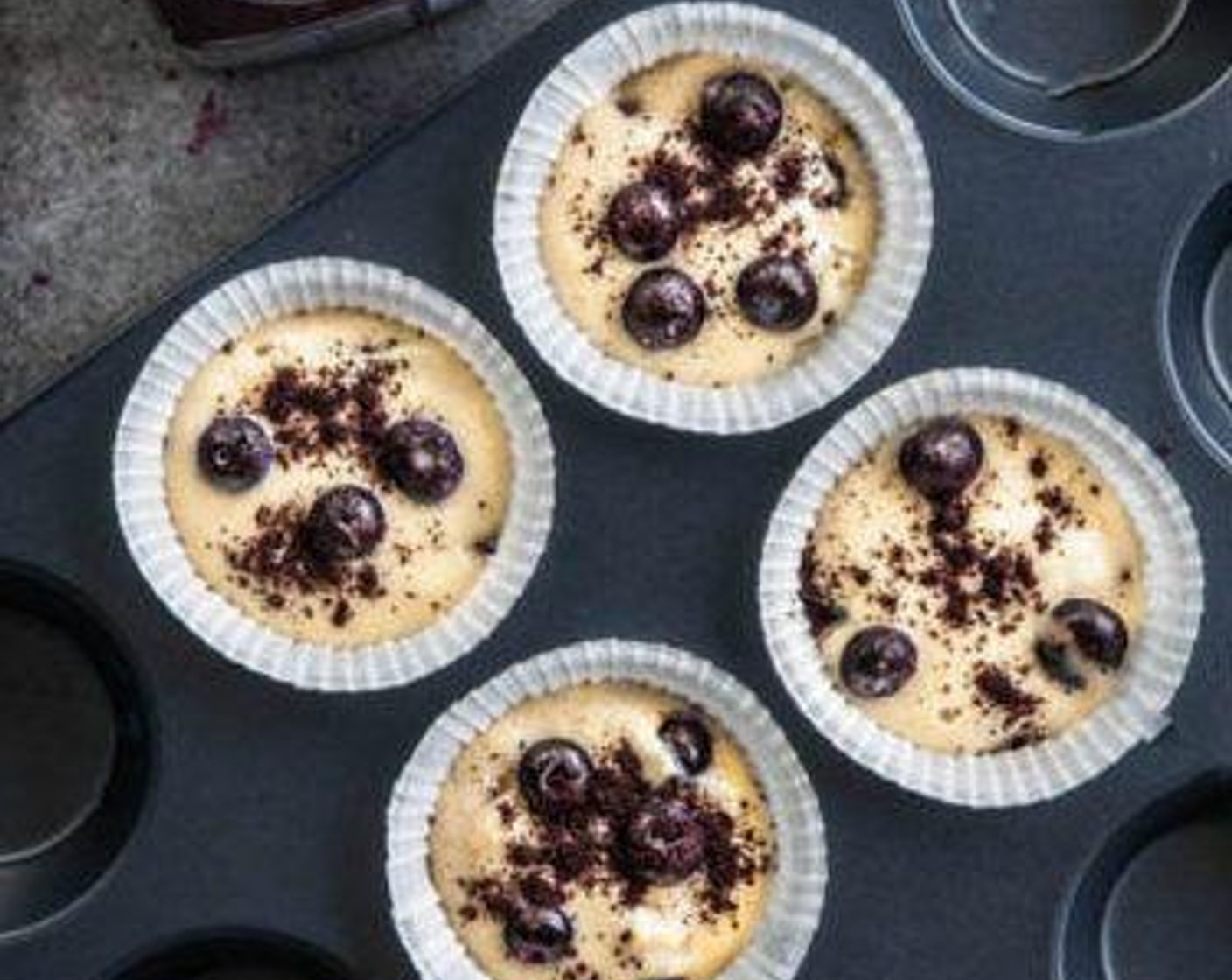 step 6 Put the muffin cases half full and then add about 5-10 blueberries.