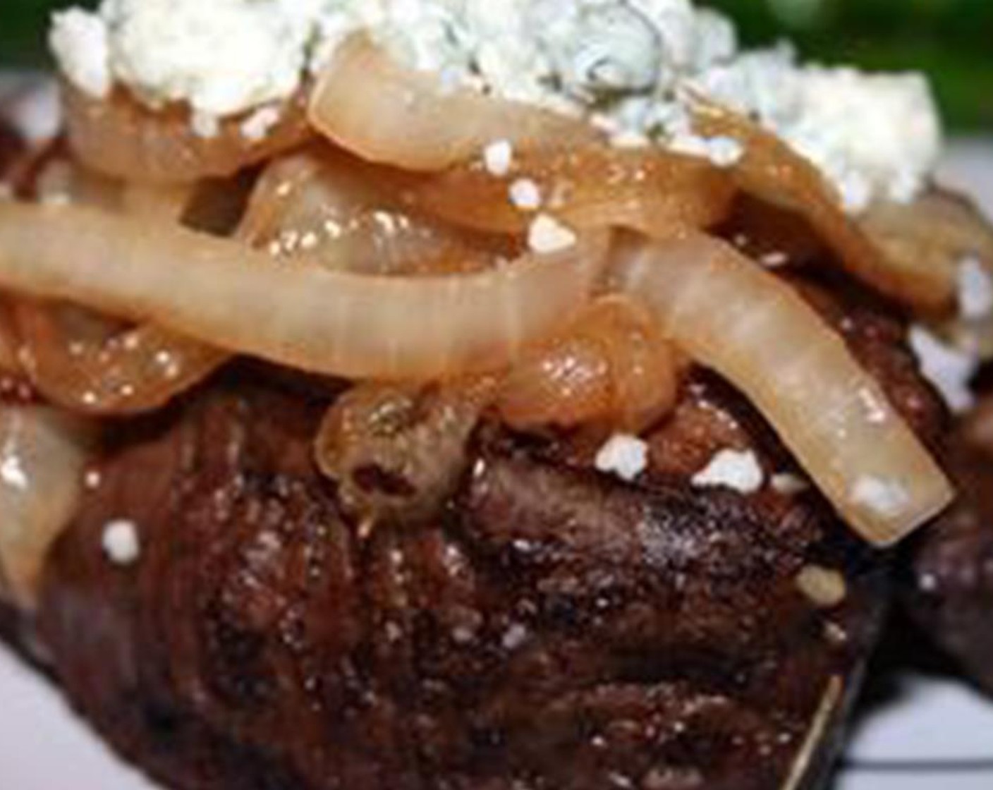 step 4 Cook your steaks through to the desired temperature either on a grill, a skillet, or in an oven. This should take around 10 minutes depending on the desired temp. A couple of minutes before your steaks are done, add a quarter of the onions on top of each filet as well as 1 ounce of Blue Cheese (3/4 cup). Cheese should be soft to melted when the stakes are served.