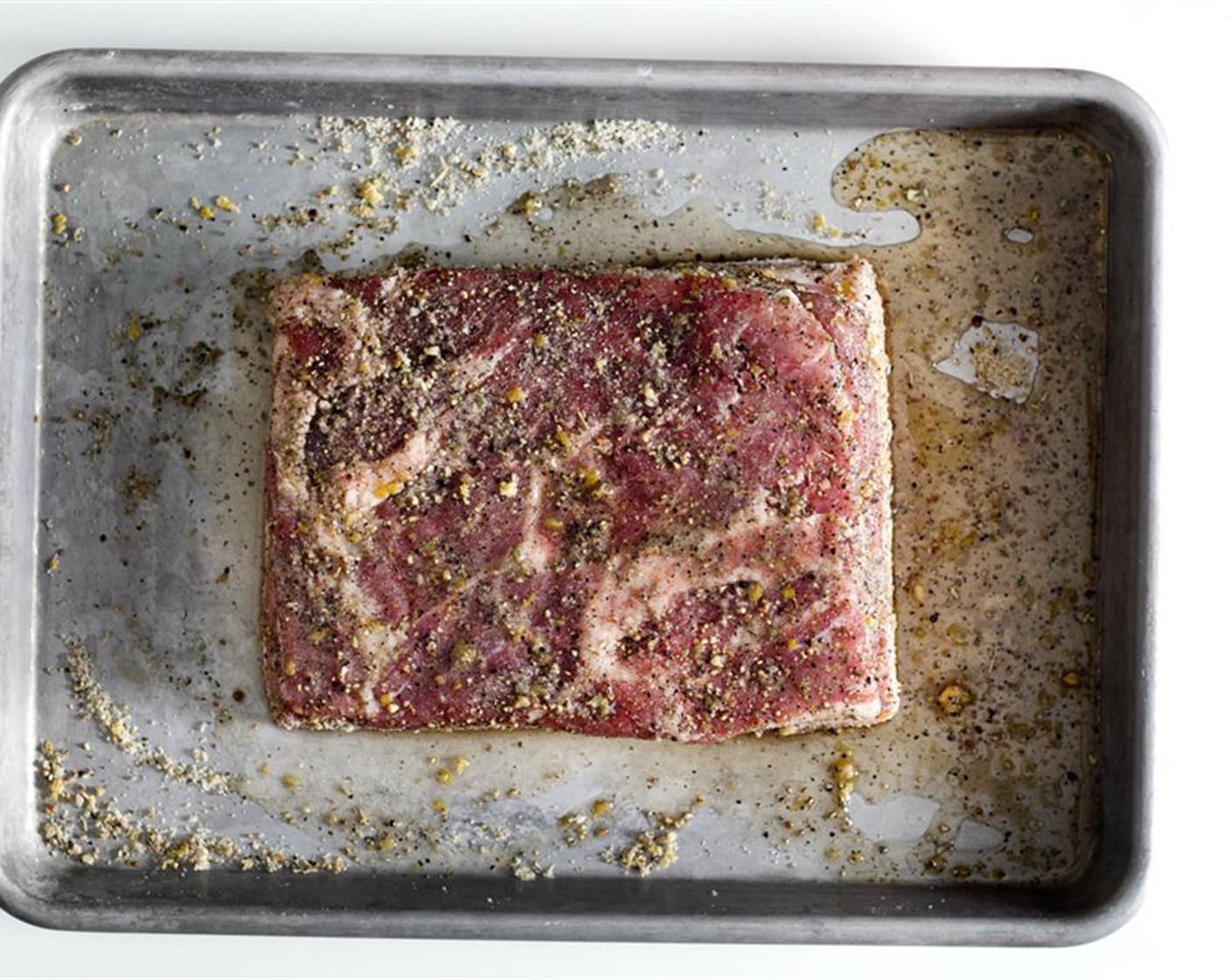step 3 Place the slab of Skin-On Pork Belly (1 piece) in a baking-sheet. Pork belly should be roughly 8 × 8-inches (can be a square or rectangle). Rub the salt-mixture evenly on all sides of the pork belly.