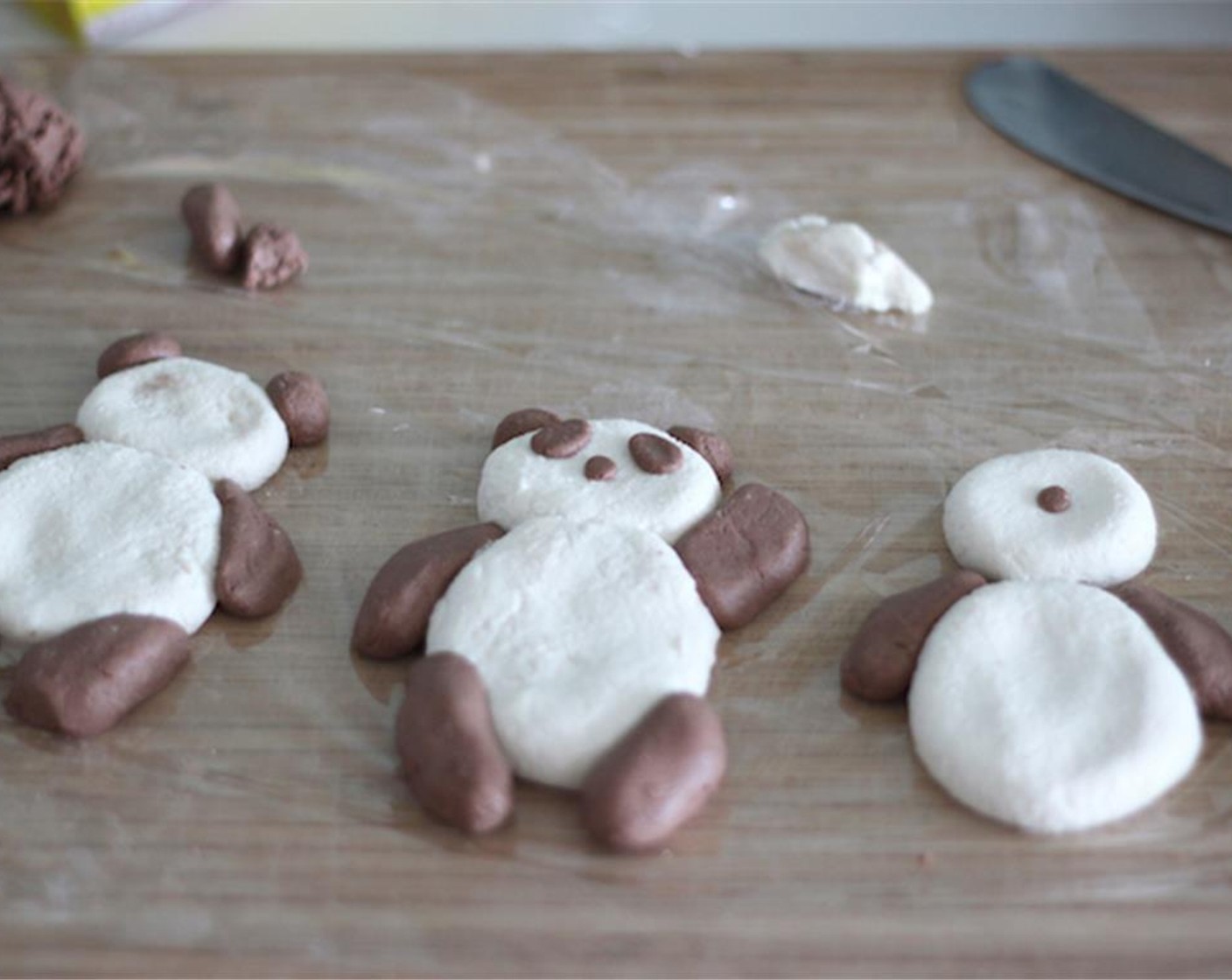 step 4 Make the pandas! When attaching ears to the face or limbs to the body, make sure the dough is sticky enough to stick together, otherwise they might fall apart when boiling. No one likes earless pandas!