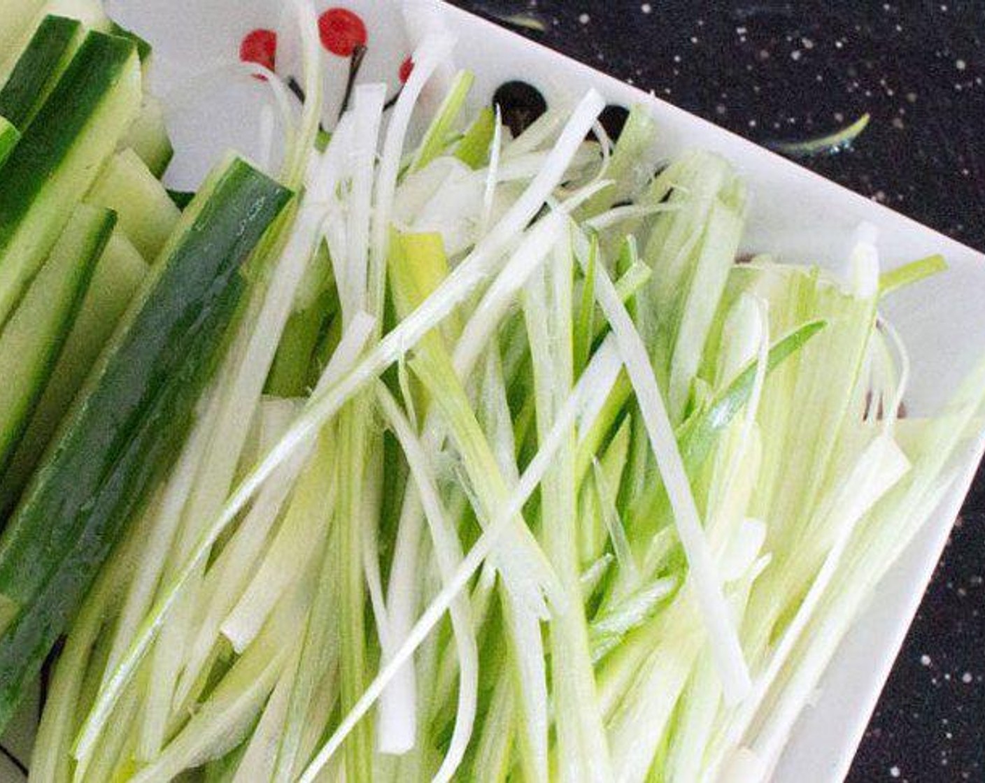 step 1 Place Spring Onions (3) and Cucumber (1/2) on a serving plate, set aside