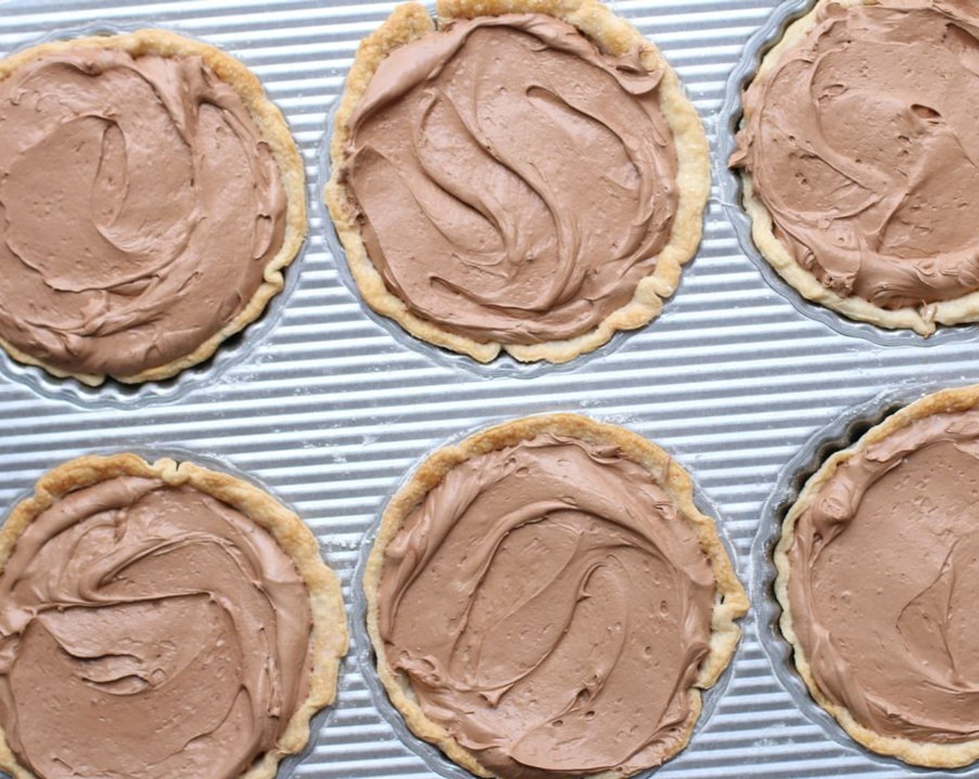 step 11 Add one container of Whipped Topping (7 1/2 cups) at a time, beating with hand mixer until well blended. Pour French Silk Mousse mixture into individual tart shells and smooth top. Chill.