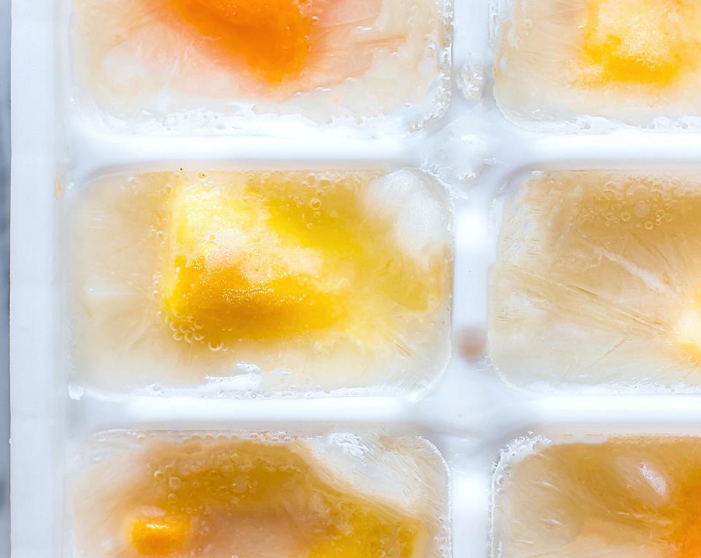 step 1 In a small ice tray, pour your Coconut Milk (3/4 cup) into the ice tray cubes. Place your Mango (1/2 cup) inside the milk cubes.
