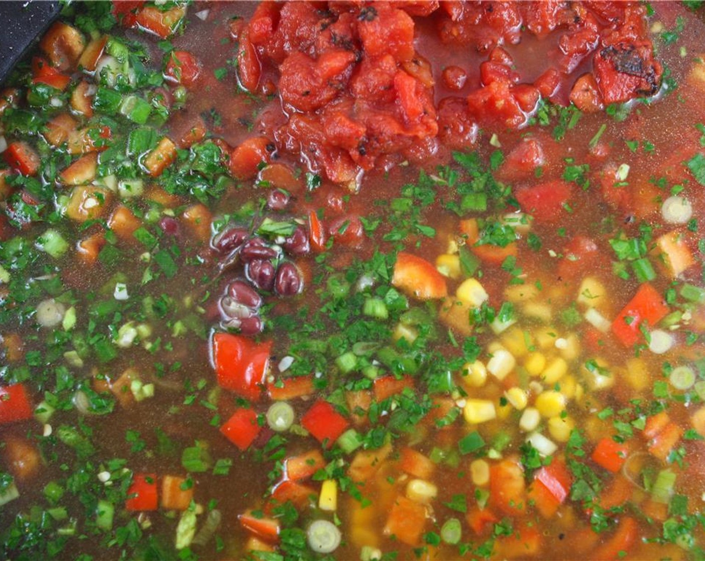 step 3 Add the Chicken Broth (32 fl oz), Diced Tomatoes (2 cans), Corn (1 can), and Black Beans (1 can) to the skillet and bring to a boil over medium-high heat. Reduce heat to medium-low and simmer for 30 minutes, stirring occasionally.