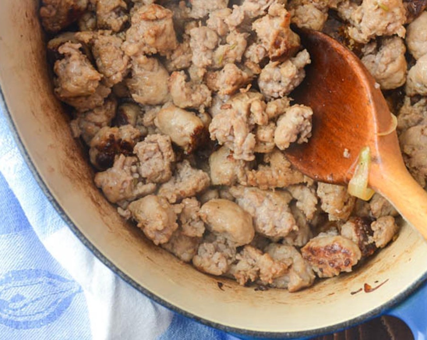 step 5 Add the sausage to the pan and break apart with a wooden spoon or large fork. Cook, stirring occasionally until sausage is browned.