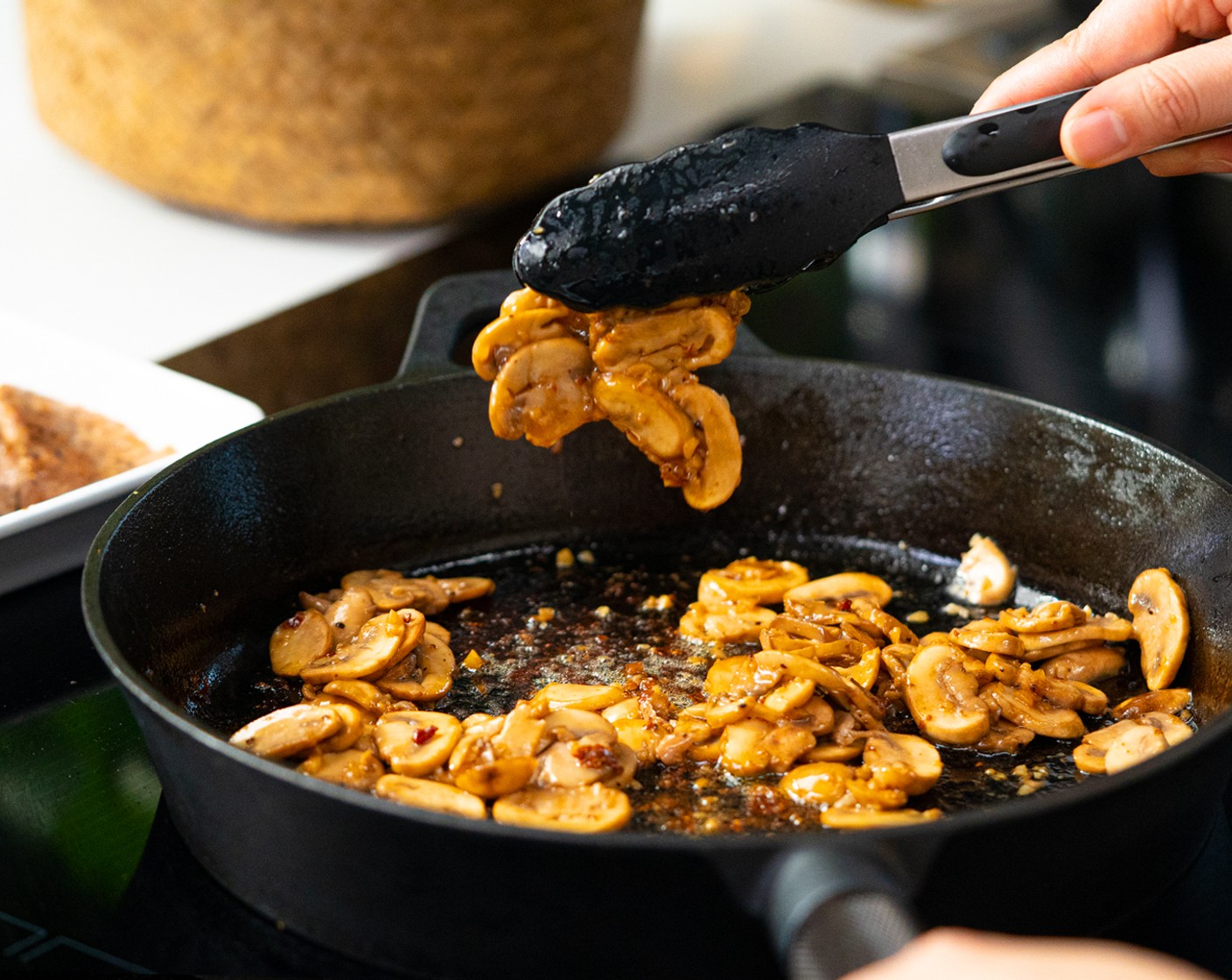 step 3 In the same skillet, add Unsalted Butter (1 Tbsp), once melted, cook the Garlic (2 cloves) until fragrant. Then add White Mushrooms (1 3/4 cups) and cook until soft, about 3 minutes.