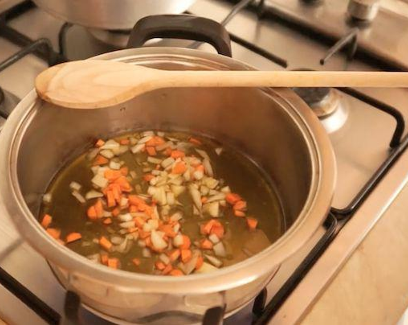 step 1 For this Italian polenta recipe, add a generous amount of Extra-Virgin Olive Oil (as needed) to a small pot, then add Carrot (1/2) and Onion (1/2) and put it on the stove on medium-low heat.