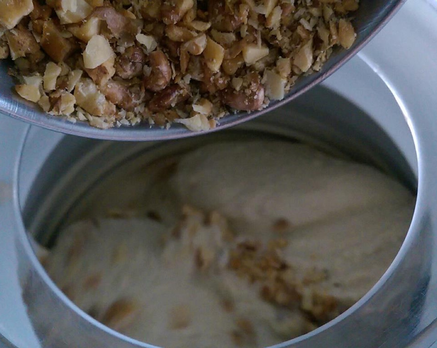 step 8 Once ice cream is starting to harden, add the roasted walnut pieces.