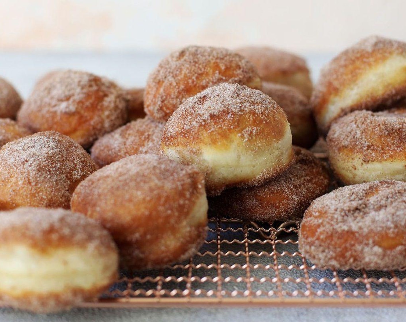 step 7 Submerge the donuts in the heated oil about 1-2 minutes on each side. Remove from the oil and put them directly into the cinnamon and sugar. Toss around and make sure they are coated before placing them on a cooling rack. Repeat with second half of the dough.