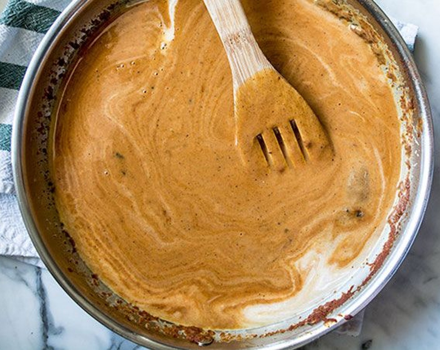 step 5 In a large saucepan over medium heat, melt the Coconut Oil (1 Tbsp) and stir in the Garlic (3 cloves). Stir frequently and cook for 2-3 minutes.