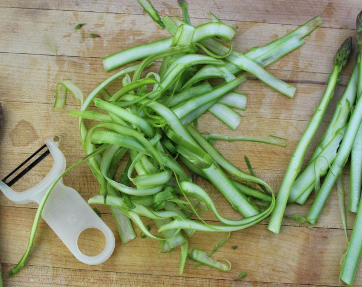 step 3 Using a vegetable peeler, peel theAsparagus (10 stalks) into thin ribbons.