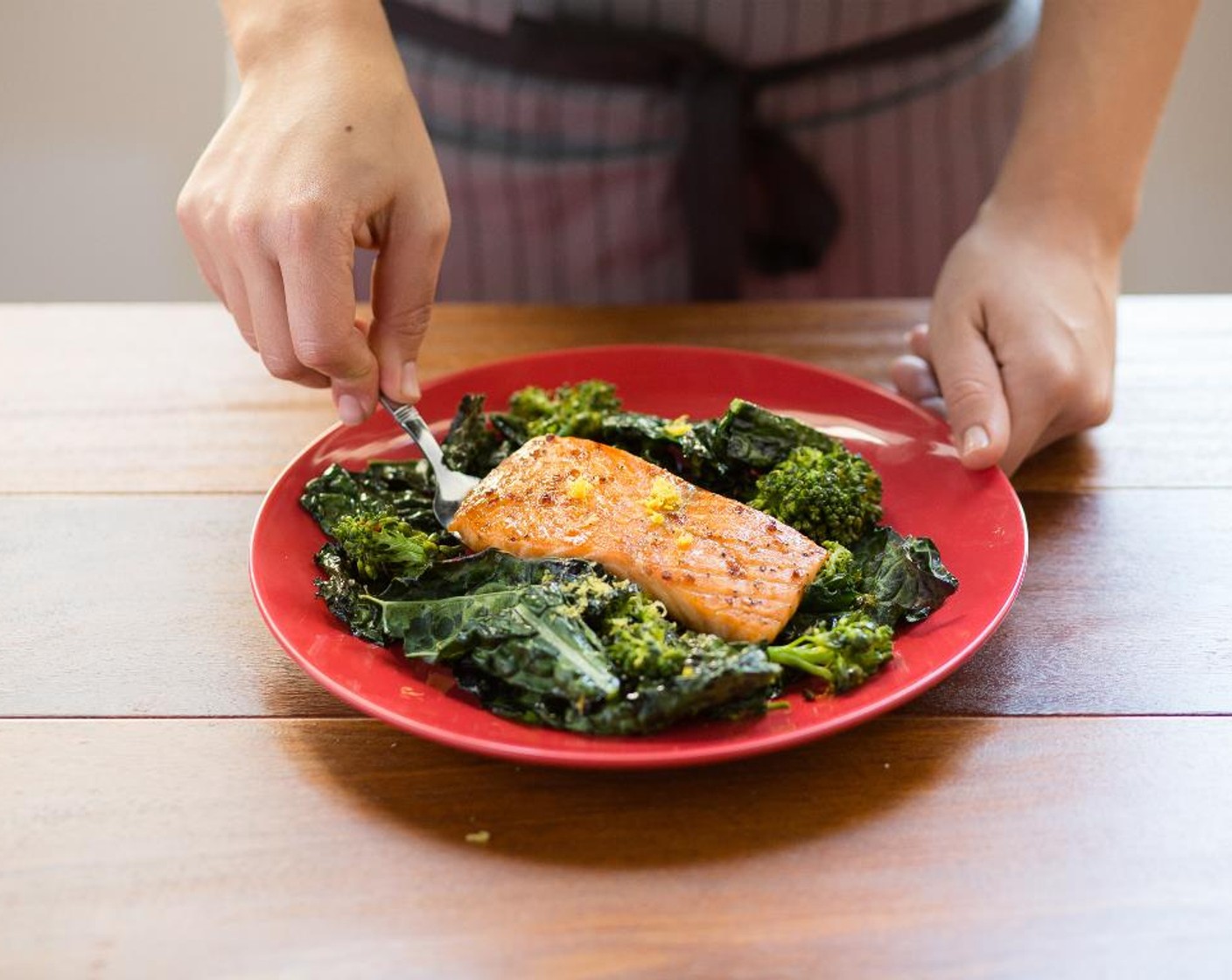 step 10 Divide the vegetables between two plates. Top each portion with a salmon fillet.