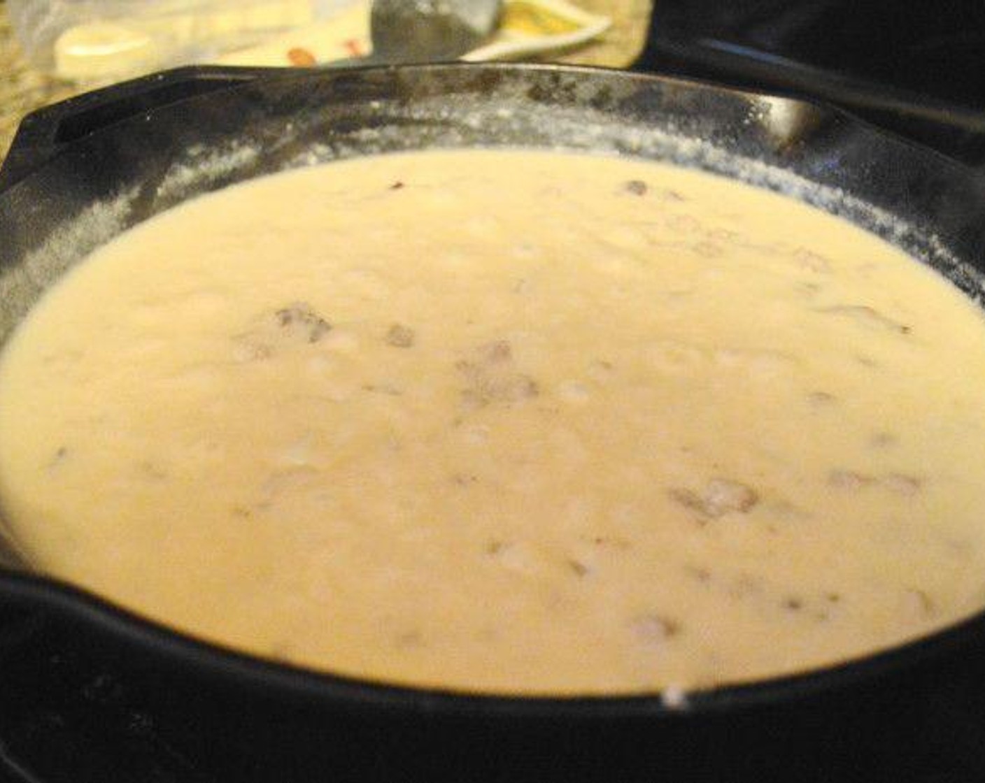 step 5 When the flour is completely cooked off after a minute or so, keep stirring while you slowly pour in the Milk (3 cups). Season the sauce with the Salt (1 pinch) and Crushed Red Pepper Flakes (1 pinch). Allow it to bubble and thicken for 10 minutes.