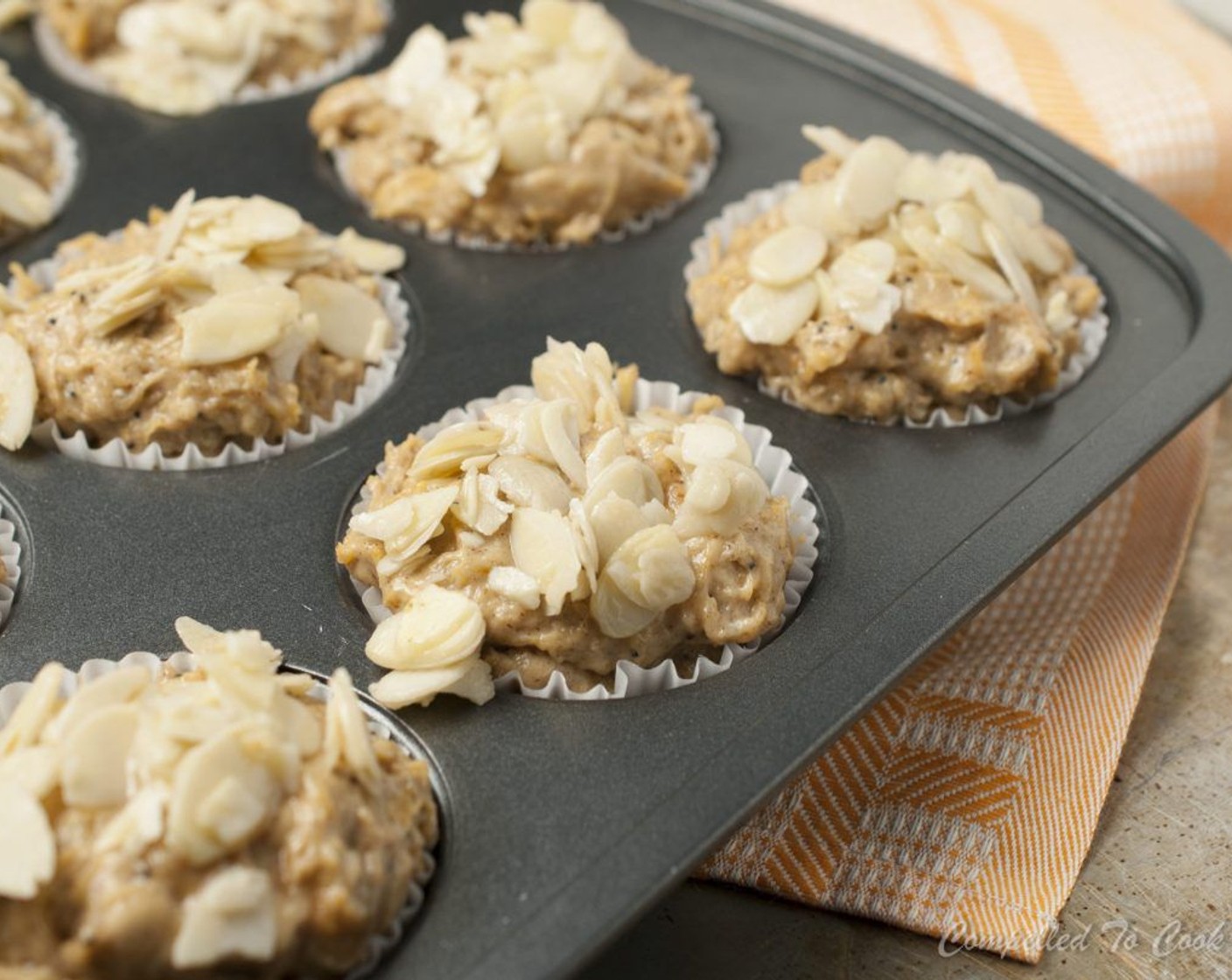 step 9 Top each muffin with a generous sprinkle of almond topping. Bake in preheated oven for 20 to 22 minutes or when a toothpick inserted comes out clean.