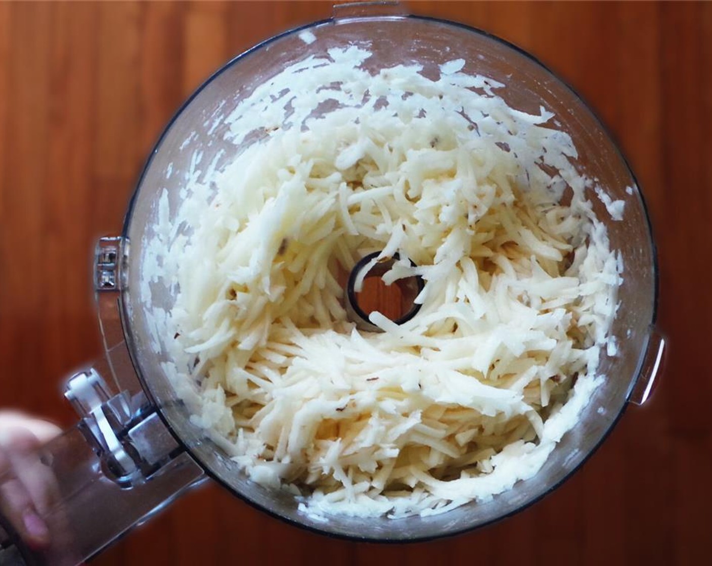 step 1 Peel the Russet Potatoes (2 lb) and grate with a box grater or food processor with attachment. Allow the potatoes to drain in a colander.