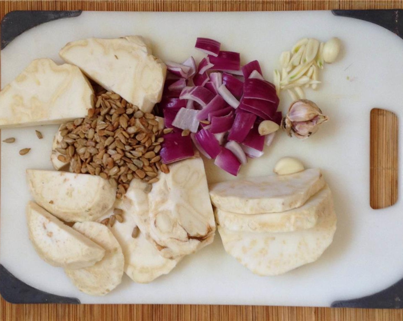 step 4 Slice the celery roots into disks, and cut the larger disks in half. Cut the Garlic (3 cloves) in half the long way and chop the Red Onion (1) into large chunks.