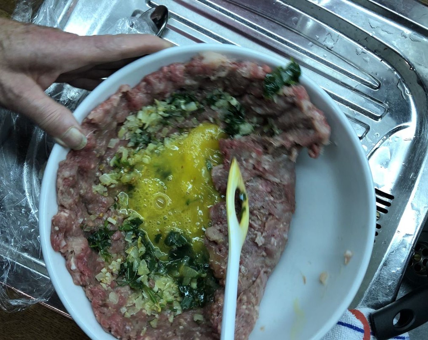 step 10 Fold ground beef in on itself towards the center, with the egg and onion mixture remaining inside the "pocket".