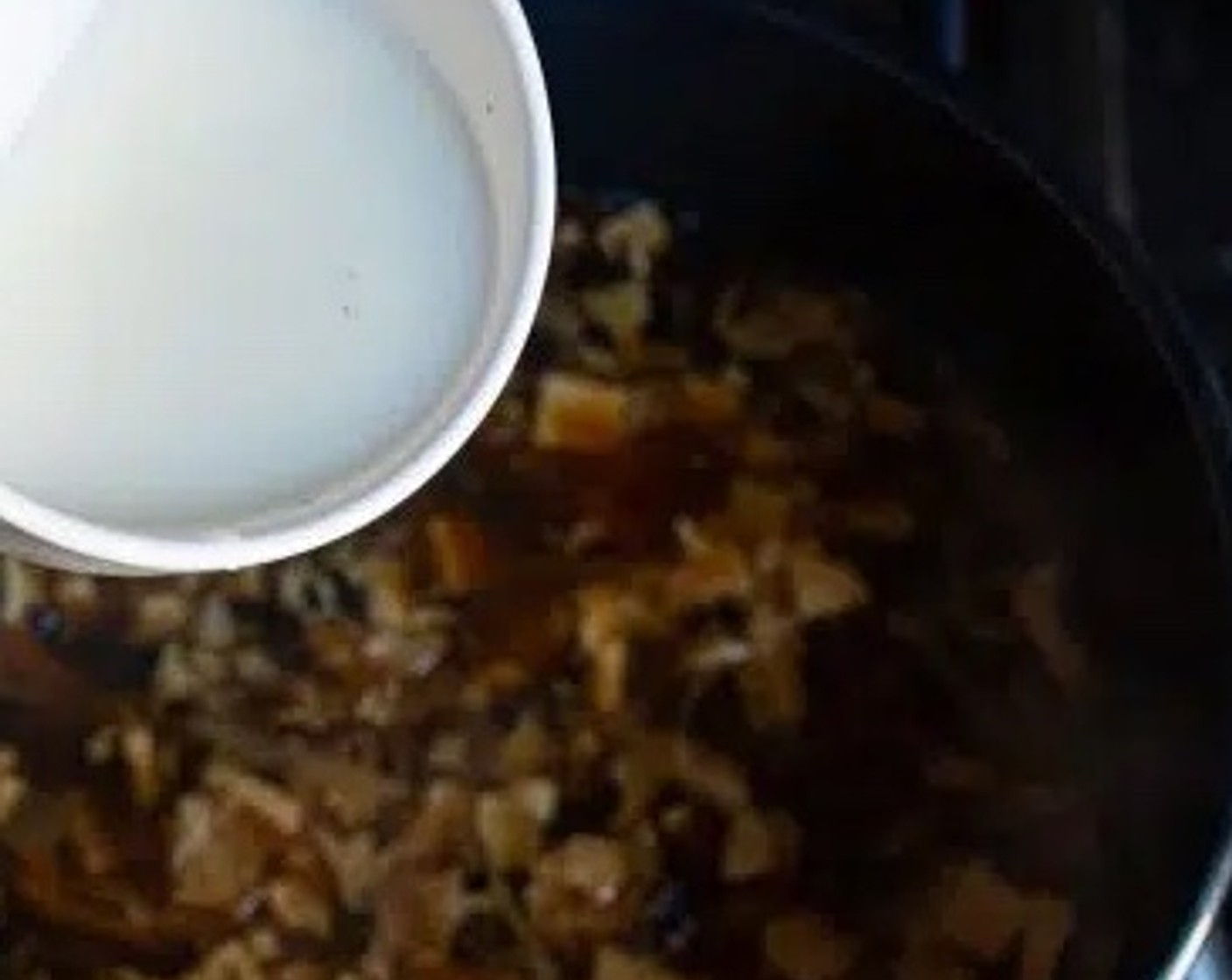 step 7 Gradually pour the cornstarch mixture into the soup, continuing to stir. The soup will slowly start to thicken.