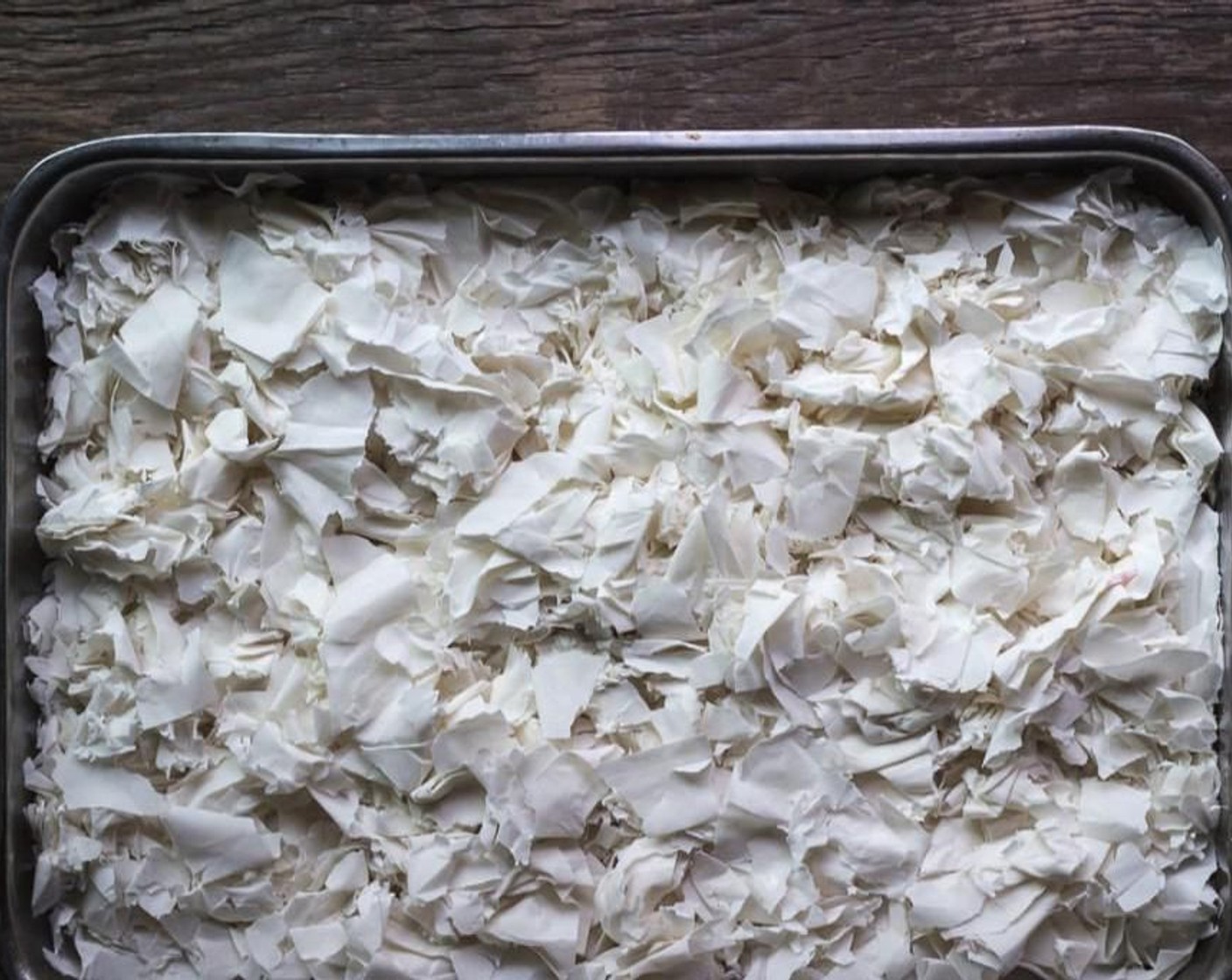 step 5 Brush a 9x13-inch stainless steel pan with 2 tbsp of Olive Oil. Tear and crumble Phyllo Dough (1 lb) sheets into approximately 2-inch pieces into the prepared pan.