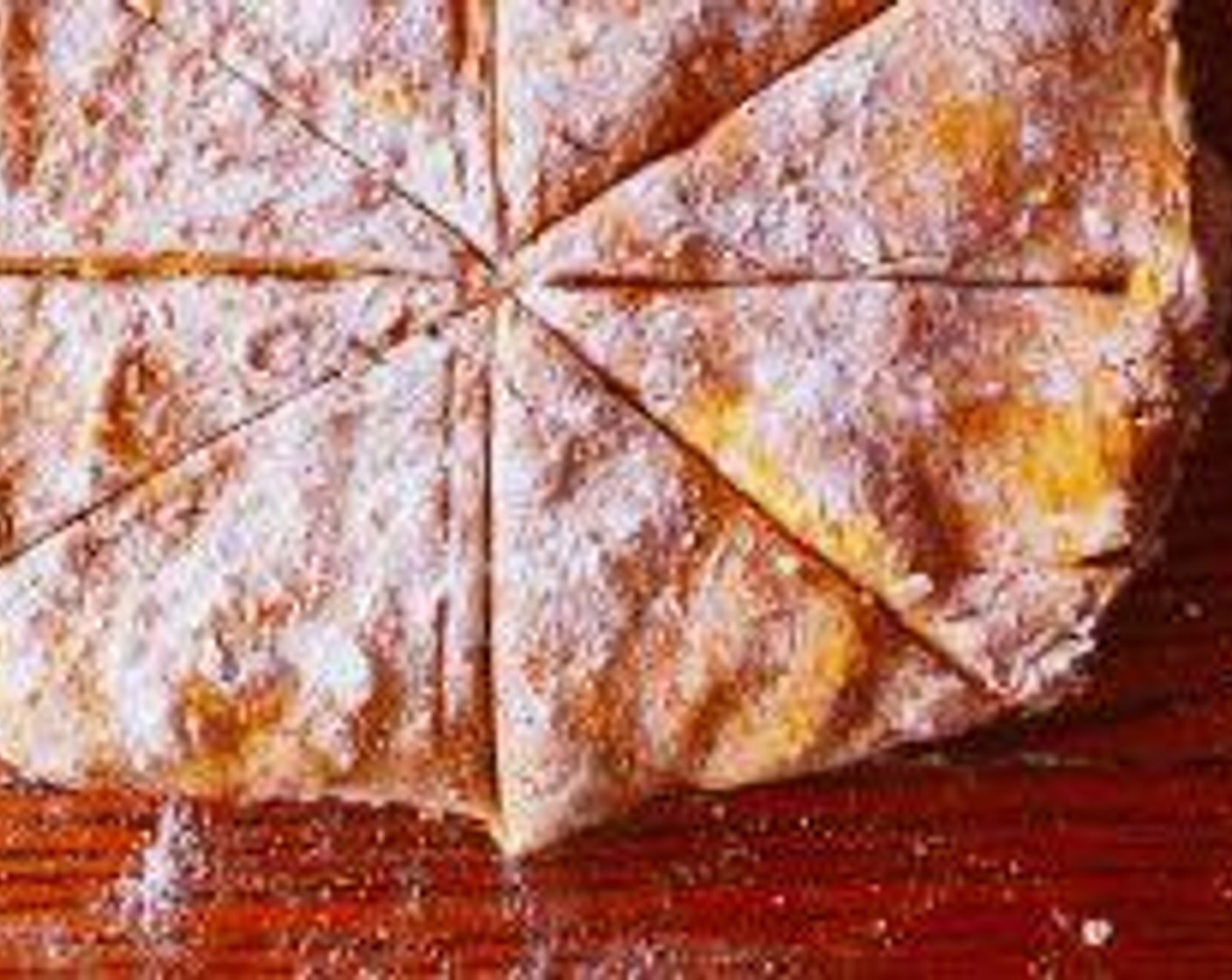 step 5 Lay on a floured surface and press into a rectangle. Cut the dough in half, then in half once more to create four squares. Cut each square in half on a bias to create a triangular scone shape.