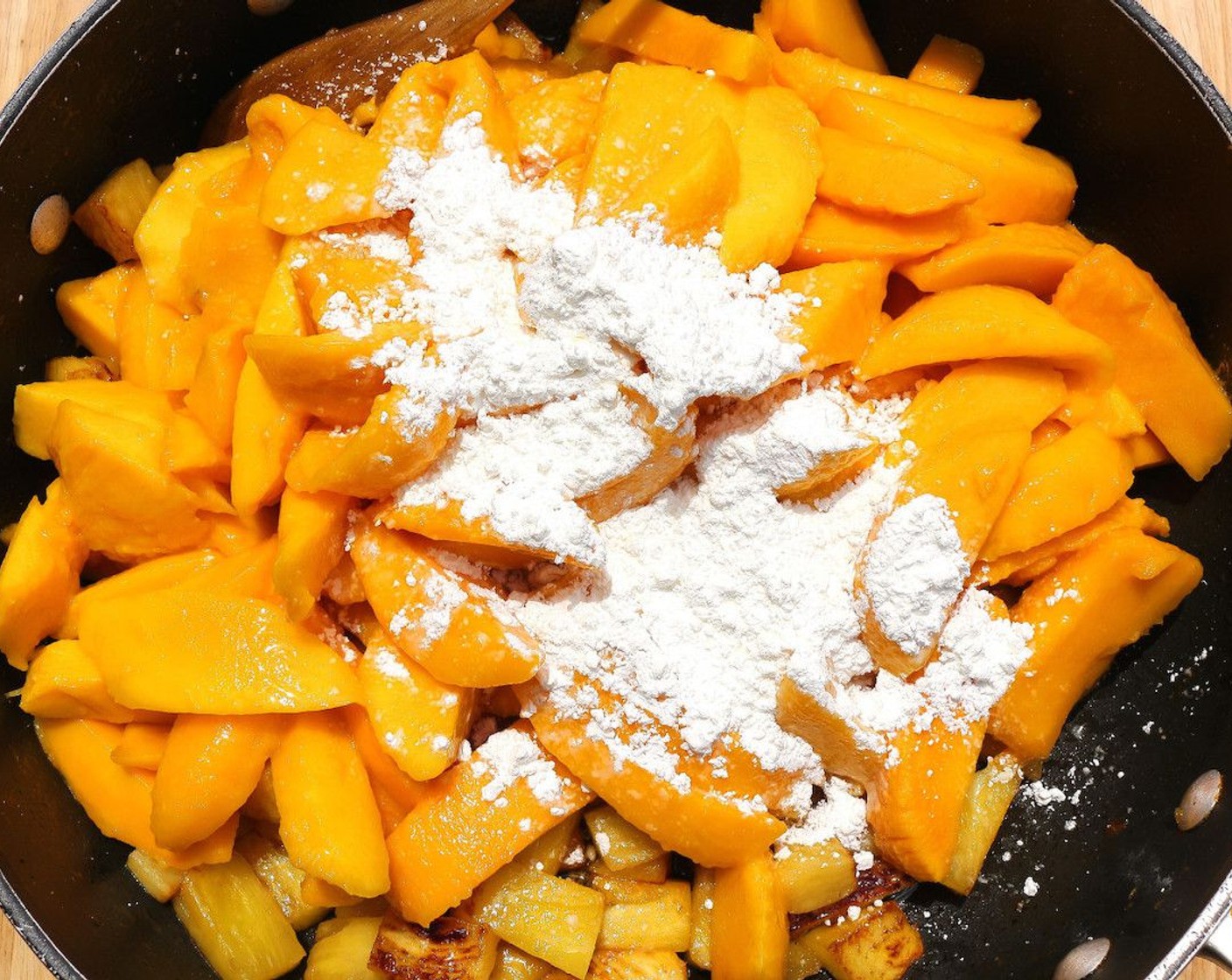 step 7 Add the mangoes and Corn Starch (1/3 cup), mix well but carefully so as not to mash-up the fruit.