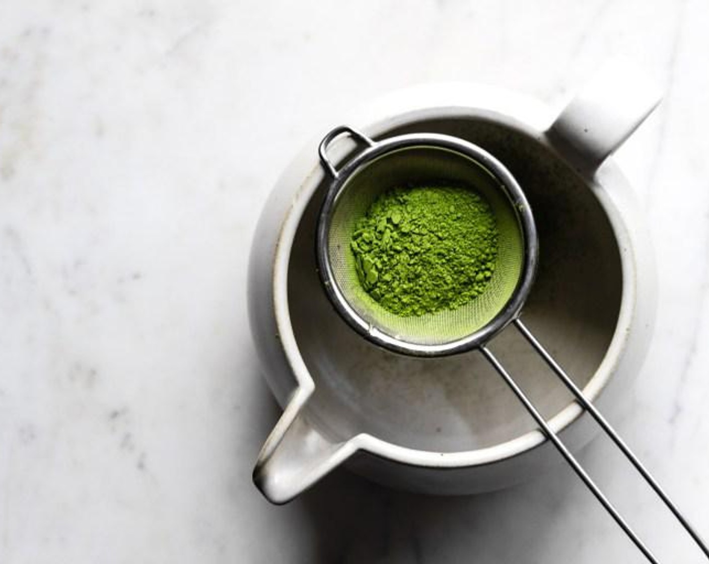 step 2 In a wide-mouthed mug or matcha bowl, sift Matcha Powder (1 tsp) through a fine sieve.