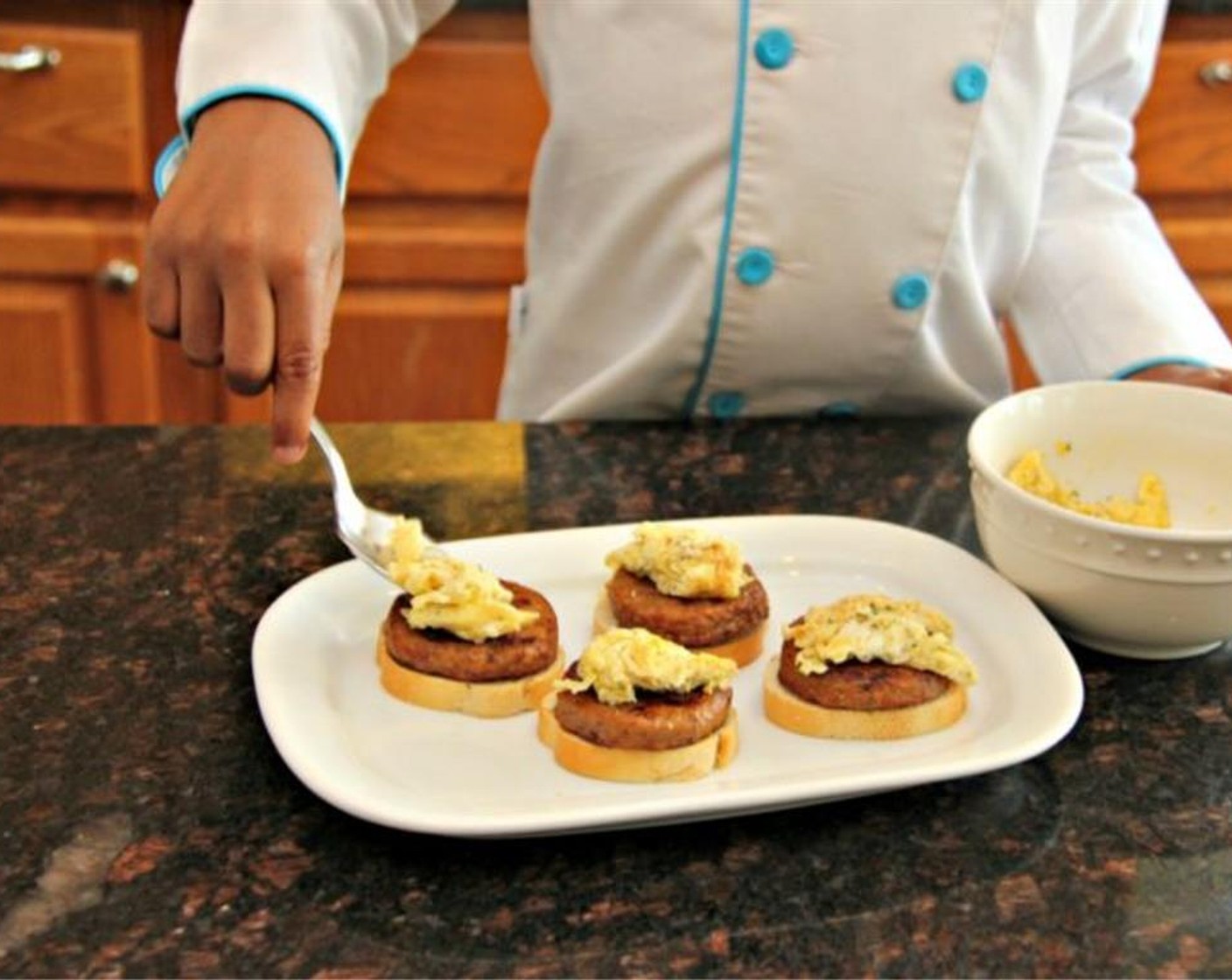 step 6 Place the sausage on the toasted bread then spoon eggs on top.