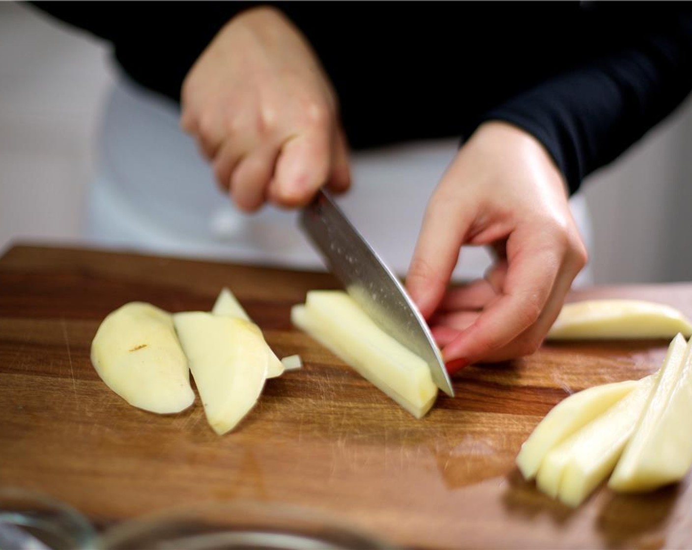 step 2 Fill a medium bowl with cold water. Peel the Russet Potatoes (2). Cut them lengthwise into quarter inch slices or planks. Stack several potato planks on top of each other and then cut them lengthwise again into quarter inch slices. Place into the bowl of water to release starch.