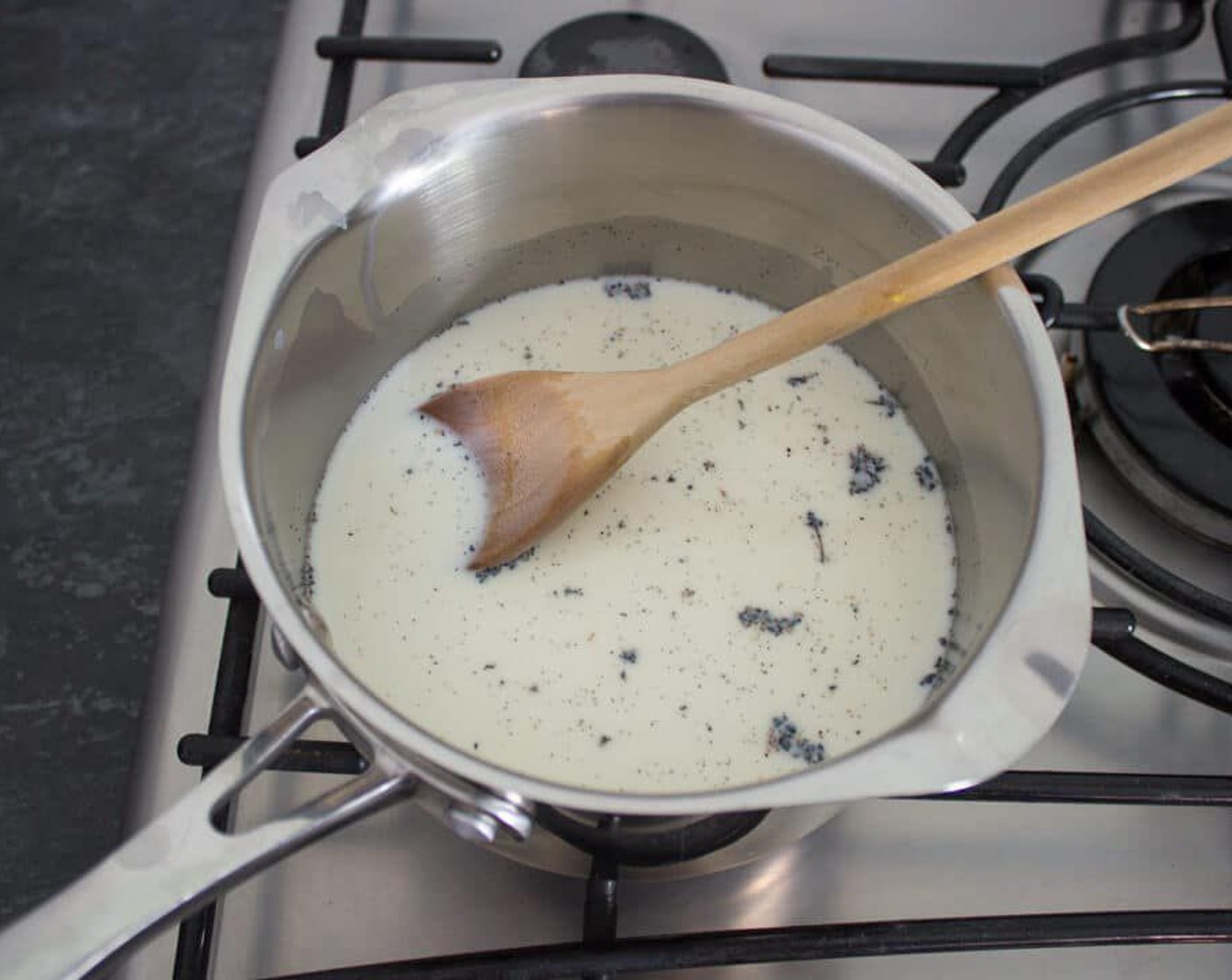 step 16 Pour the Whole Milk (1 cup) into a large, heavy base saucepan. Split the Vanilla Bean Pod (1), scrape out the seeds and put into the milk along with the empty pods. Bring it to the boil then remove from the heat.