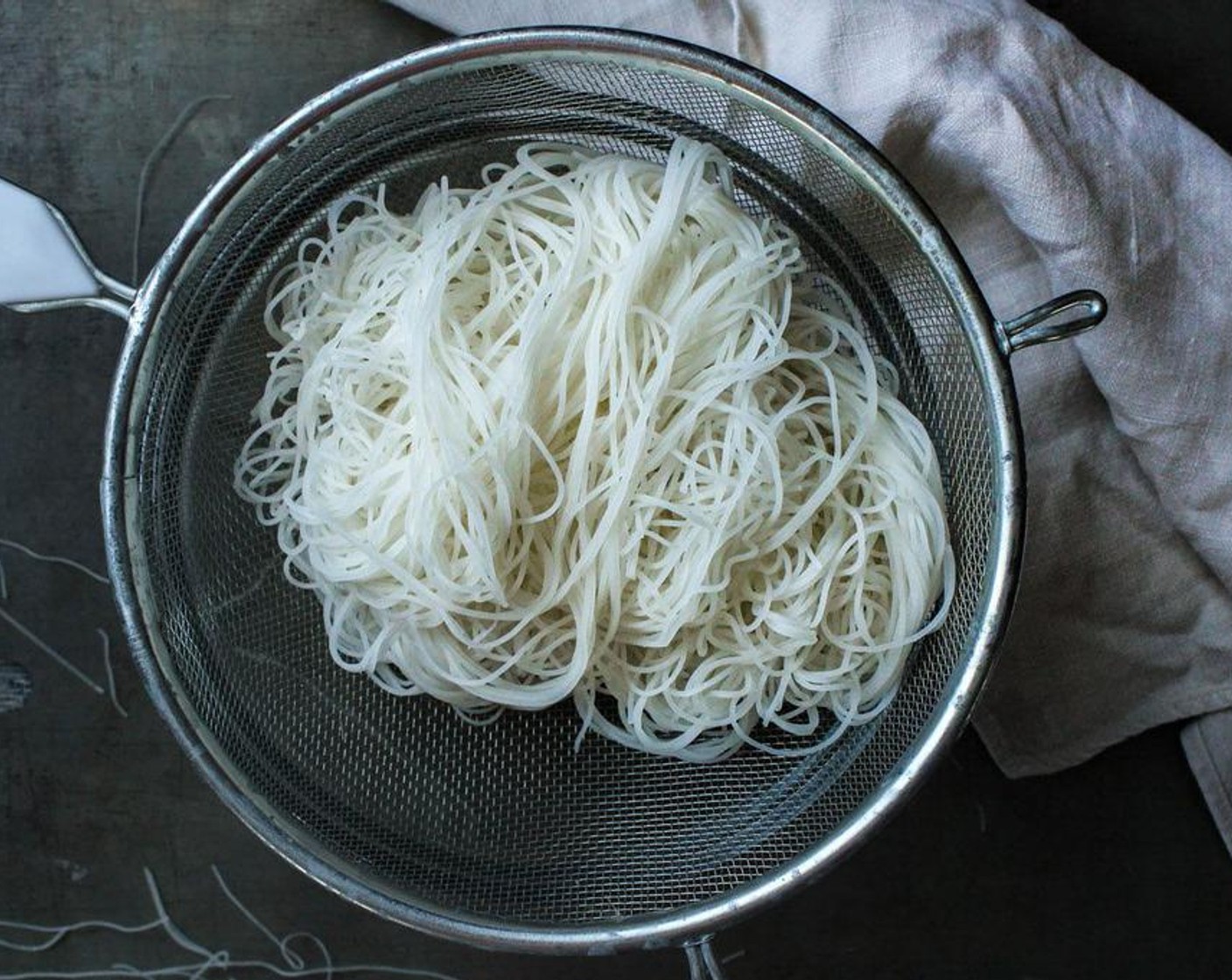 step 2 Strain the noodles through a strainer or sieve after they are pliable and feel soft, then put them back in the bowl and quickly cover with a towel to steam them for another 3 minutes.