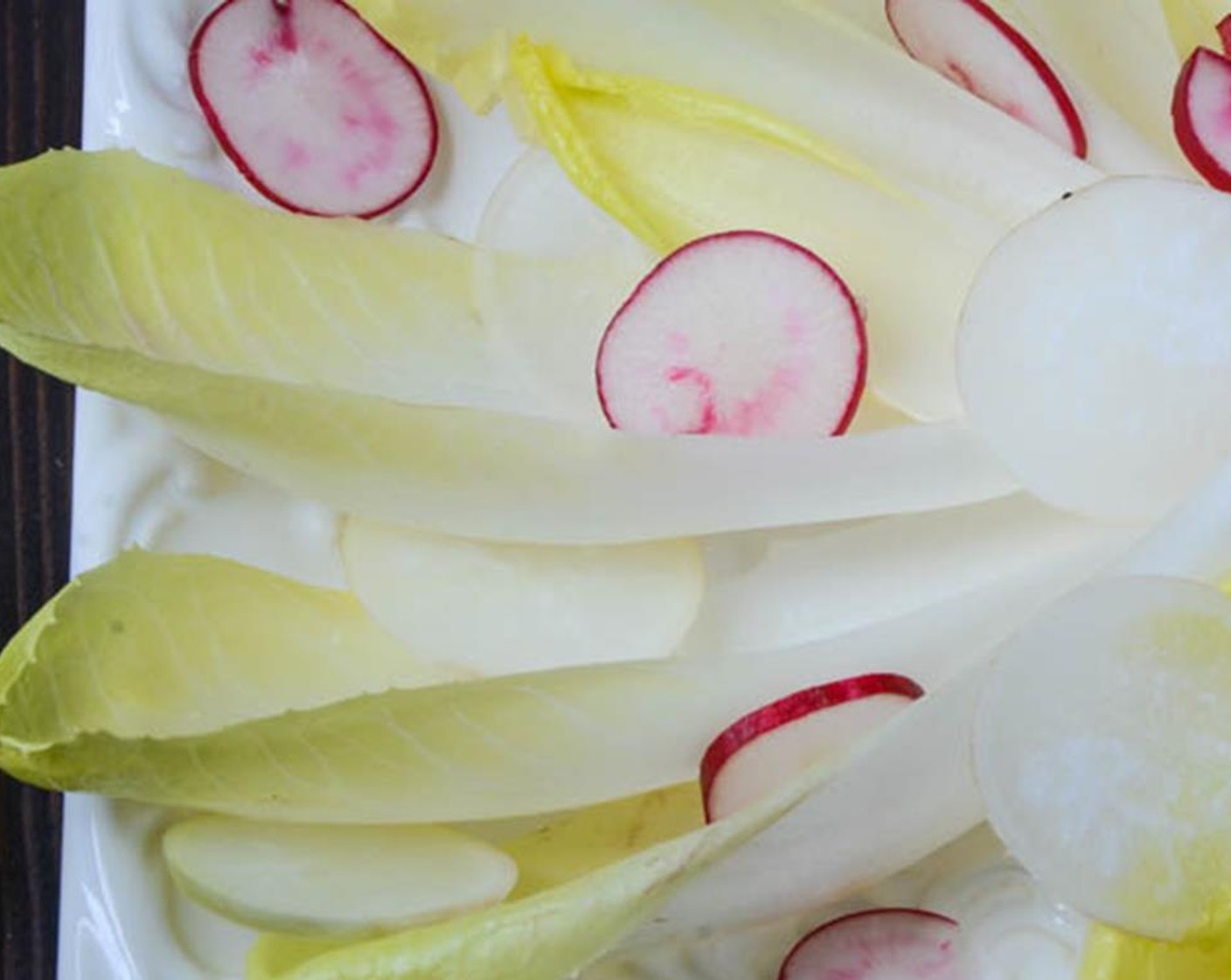 step 6 Add the Radish (1 bunch) and sliced Apple (1/2), tucking them in and around the endive.