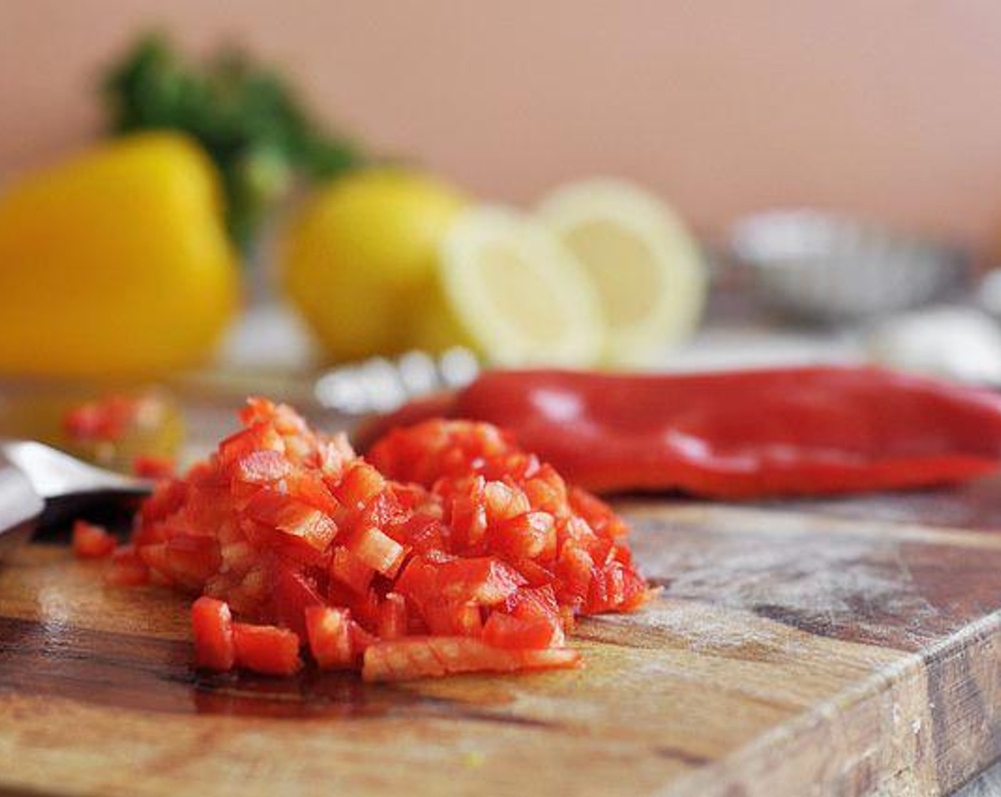 step 3 While waiting for the oven to preheat, begin chopping the Red Onion (1), Red Bell Pepper (1), Yellow Bell Pepper (1), Garlic (3 cloves), Celery (4 stalks), Fresh Parsley (1 handful), and Capers (1 Tbsp).