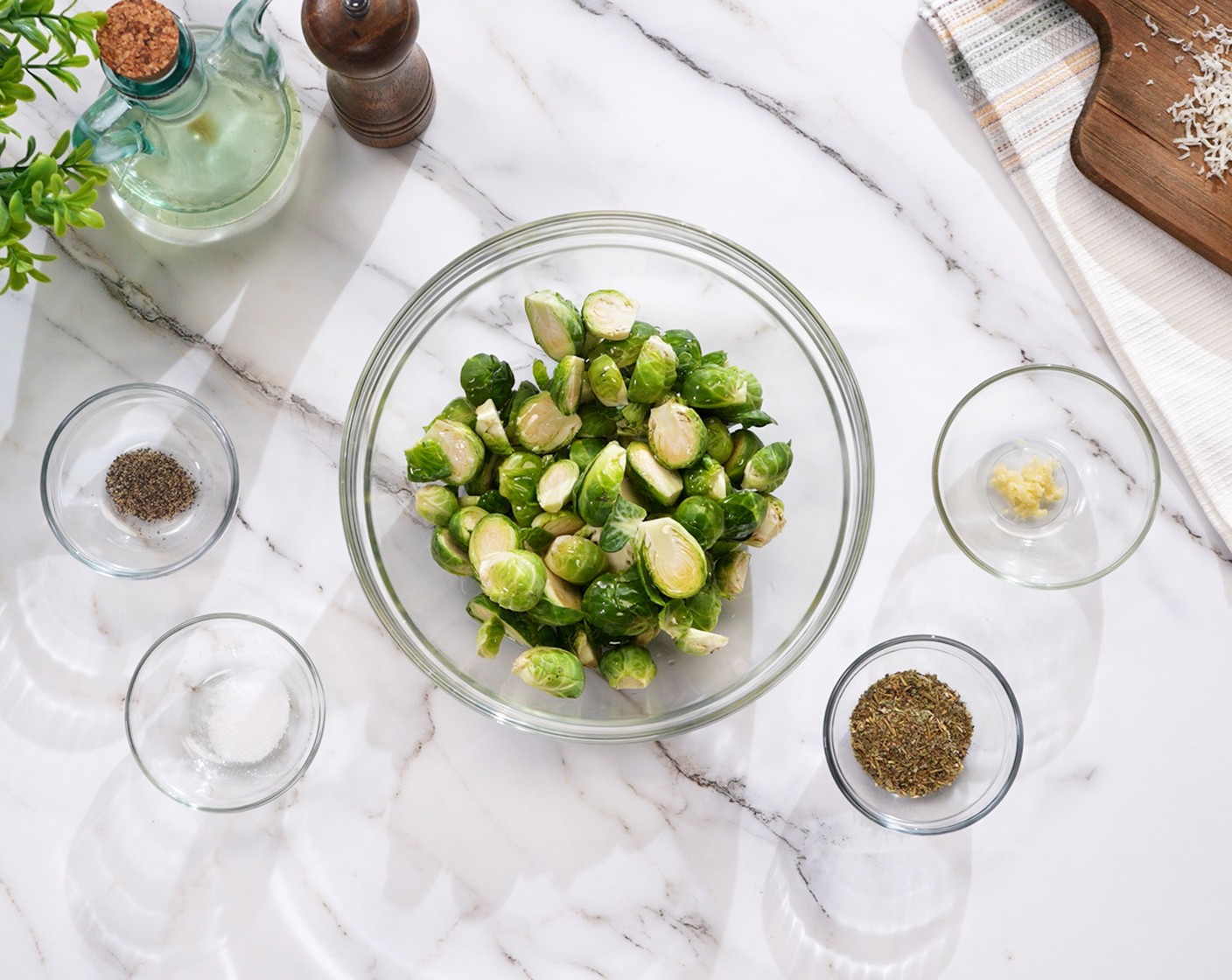 step 1 In a large bowl, toss the Brussels Sprouts (5 cups) with Olive Oil (1 Tbsp), Garlic (1 clove), Italian Seasoning (1 Tbsp), Salt (1/2 tsp), and Ground Black Pepper (1/4 tsp).