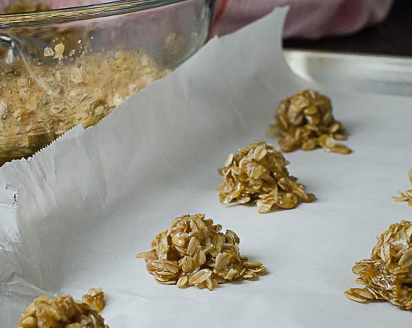 step 4 Line a sheet pan with parchment paper. With a teaspoon, scoop out rounded spoonfuls onto the parchment paper, leaving about 2 inches around the perimeter of the cookies, which will spread as they bake.