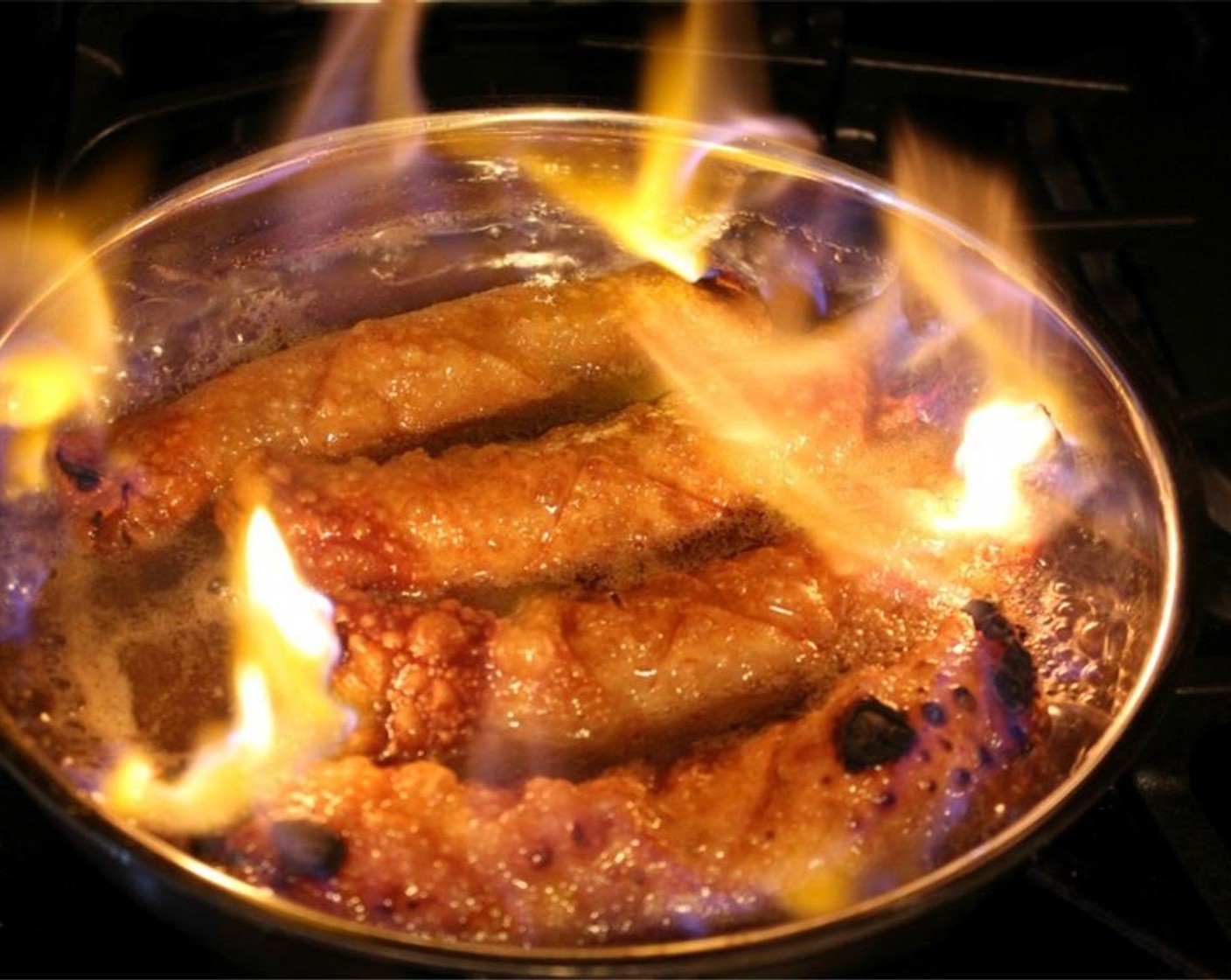 step 9 Light up that pan with a lighter.  The flames will stay contained in the pan until they go out on their own.  If the bananas are getting too dark, simply cover the pan with the sheet pan to put out the flames.