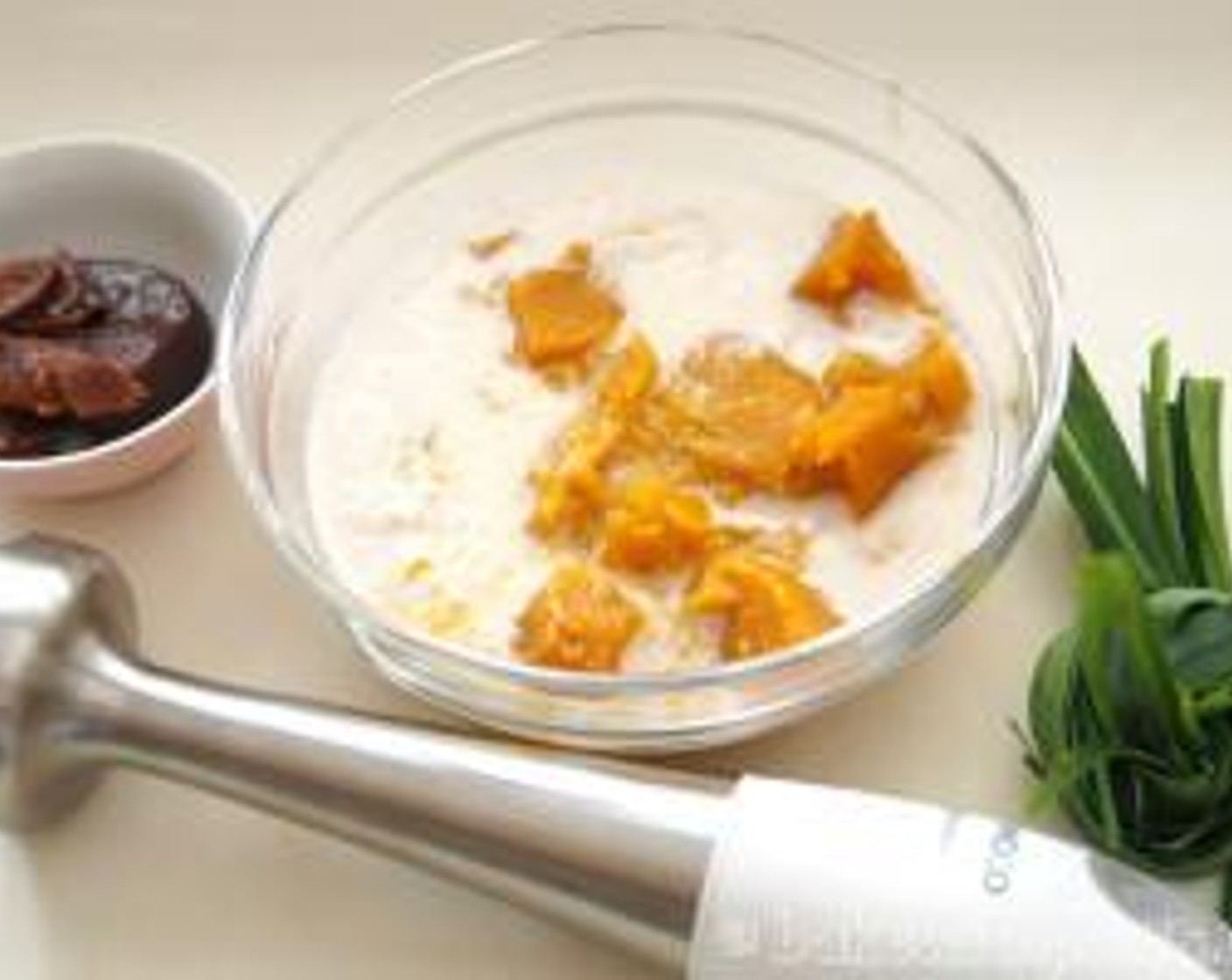 step 2 In a big bowl, add in pumpkin and Coconut Milk (1 cup) then blend with hand blender till smooth.