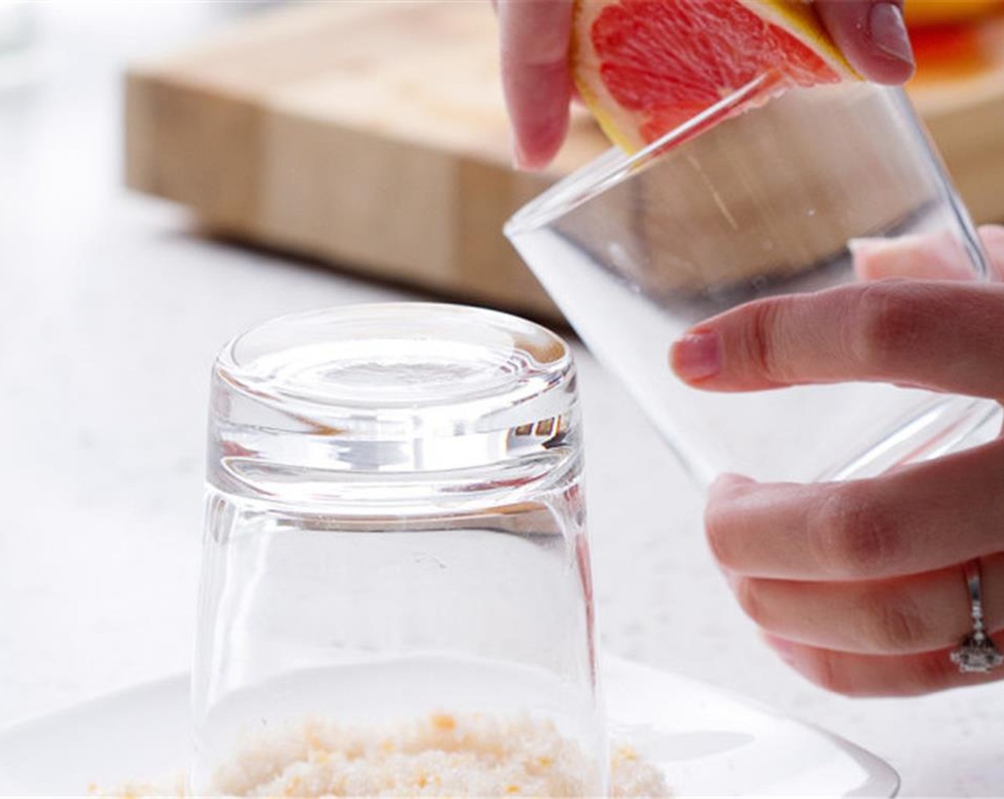 step 4 Combine the grapefruit zest, Granulated Sugar (2 Tbsp) and Salt (1 Tbsp) on a plate. Take a grapefruit slice, and run it along the edges of the glasses. Dip edges into zest mixture to fully coat.